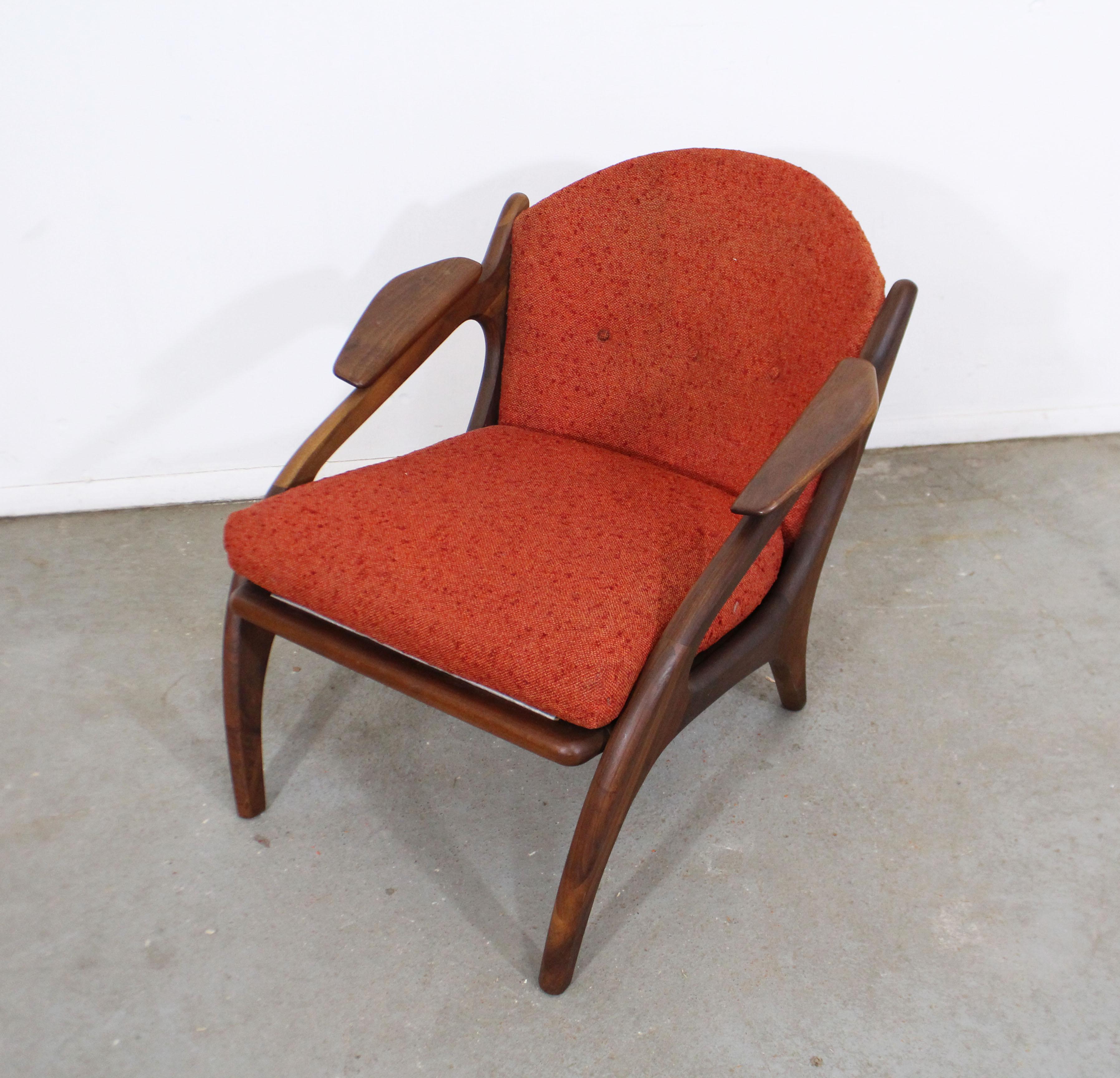 Offered is a Classic Mid-Century Modern lounge chair, designed by Adrian Pearsall for Craft Associates (#2249-C). Has a walnut base with uniquely sculpted arm rests and red upholstery. It is in good condition, but should be reupholstered, showing