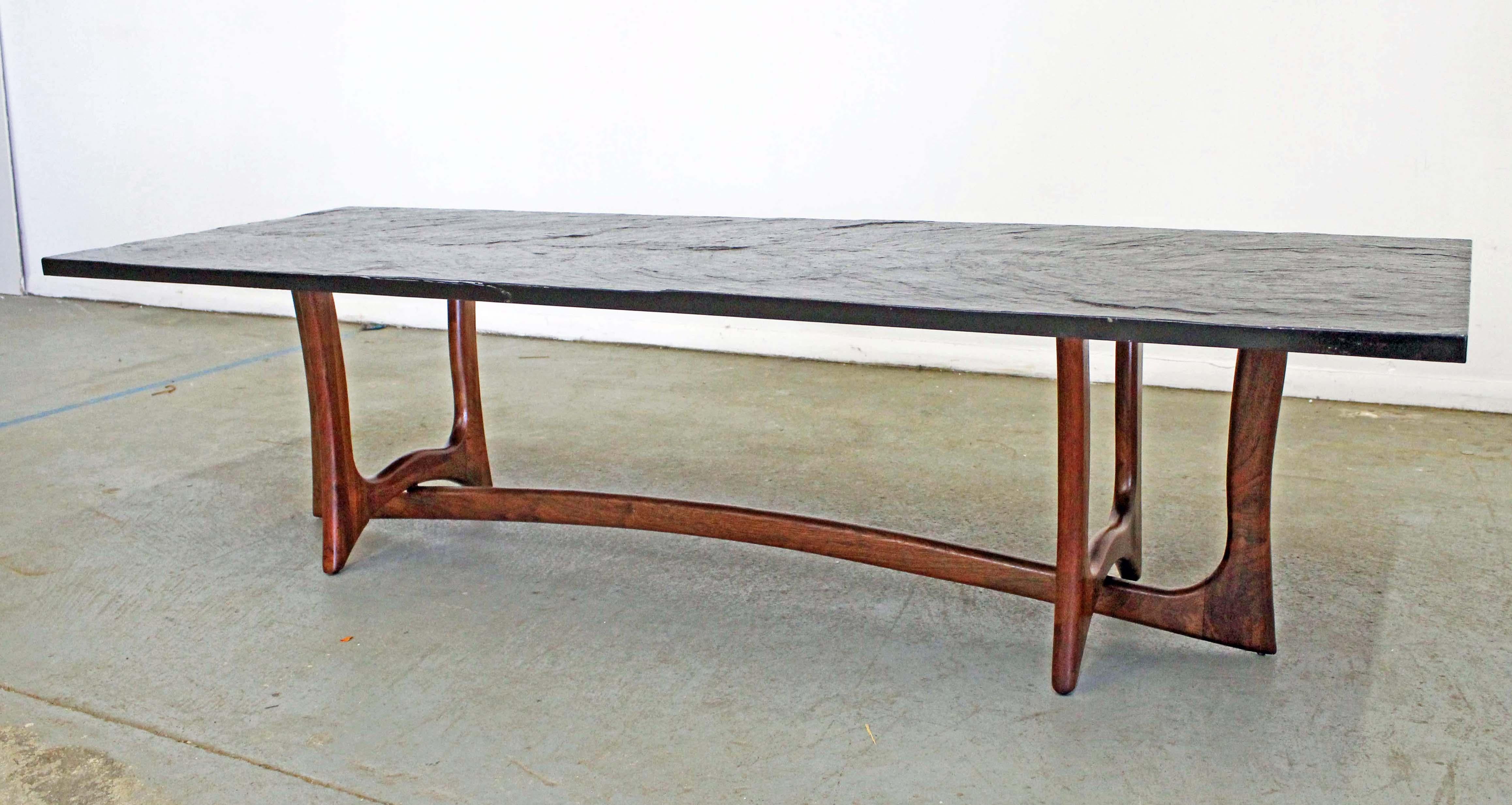 Offered is an authentic Adrian Pearsall coffee table with a gorgeous sculptural wooden base and slate top. It was designed by Adrian Pearsall for Craft Associates. It is in good condition for its age showing normal wear. Slate top has some stains