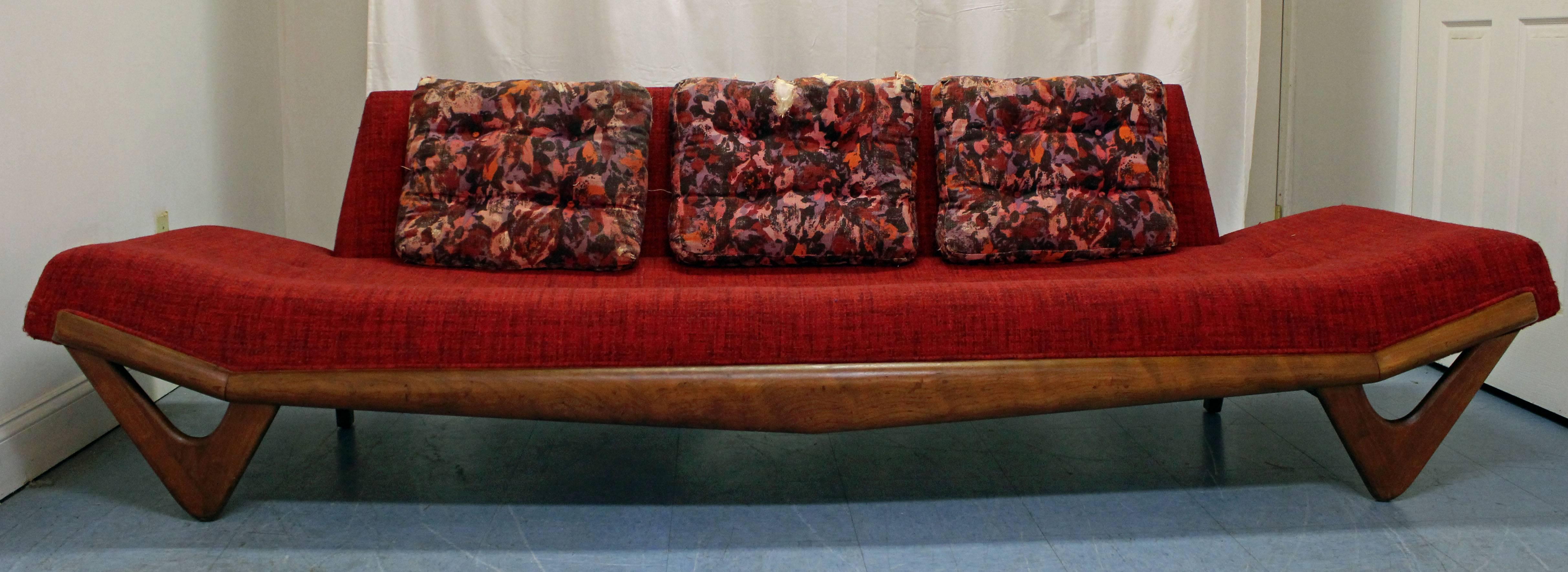 This is an original Pearsall sofa. It features a walnut base with 