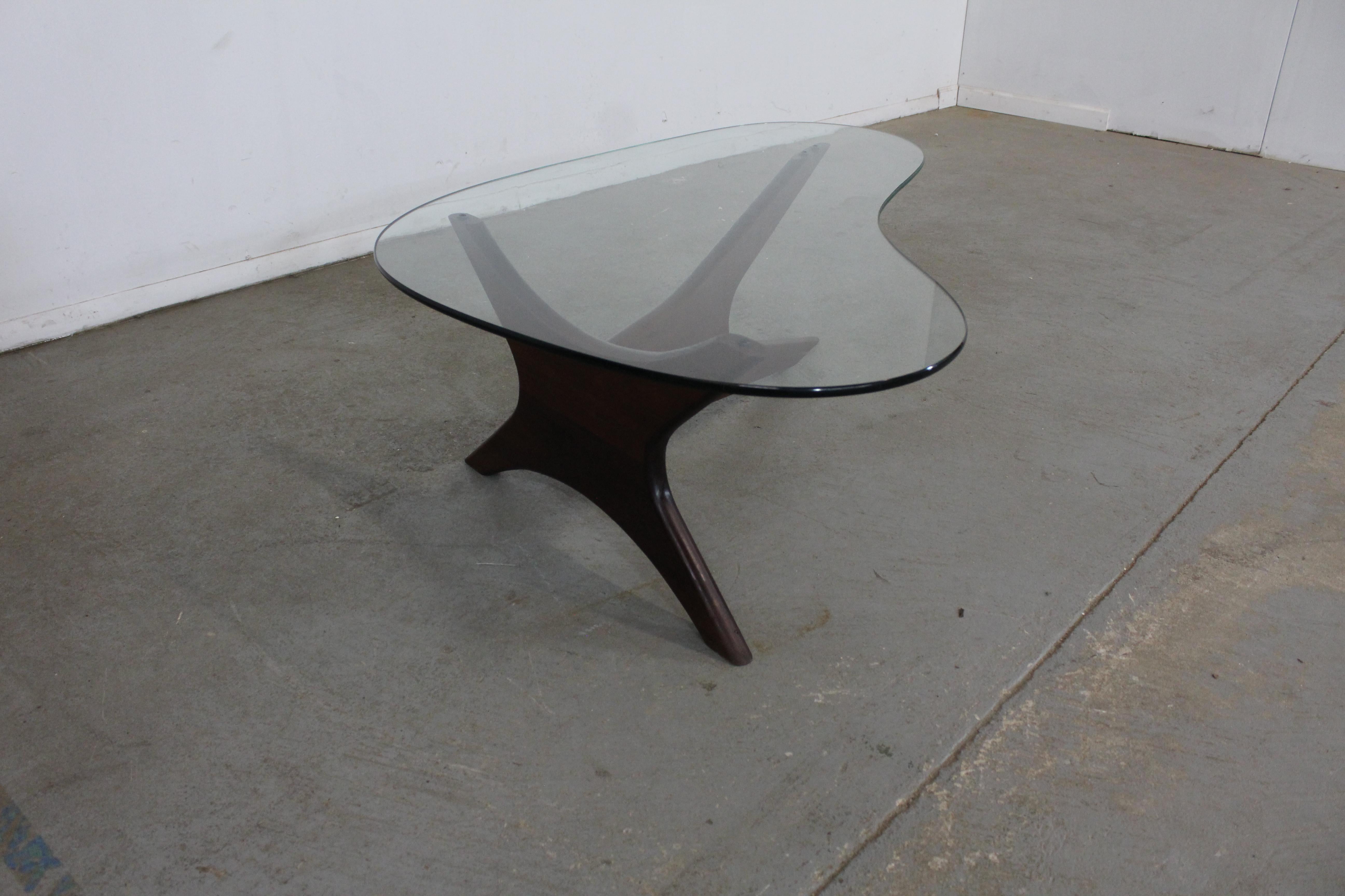 Offered is an authentic Adrian Pearsall 'Stingray' coffee table with a gorgeous sculptural wooden base and glass top. It was designed by Adrian Pearsall for Craft Associates. It is in good condition for its age, shows small chips and surface