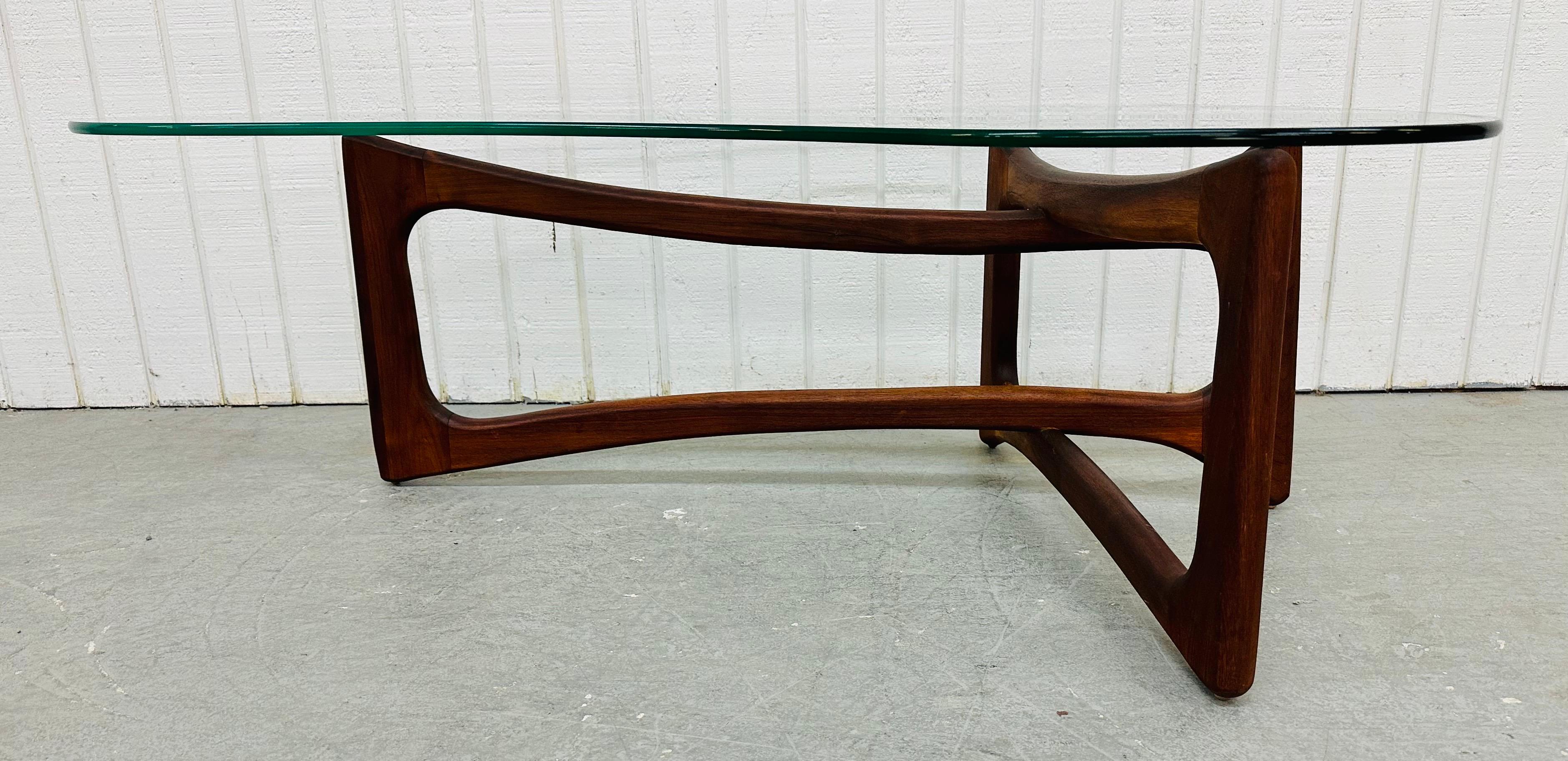 This listing is for a Mid-Century Modern Adrian Pearsall Coffee Table. Featuring a kidney shaped glass top, boomerang shaped solid wood base, and a beautiful walnut finish. This is an exceptional combination of quality and design by Adrian Pearsall!