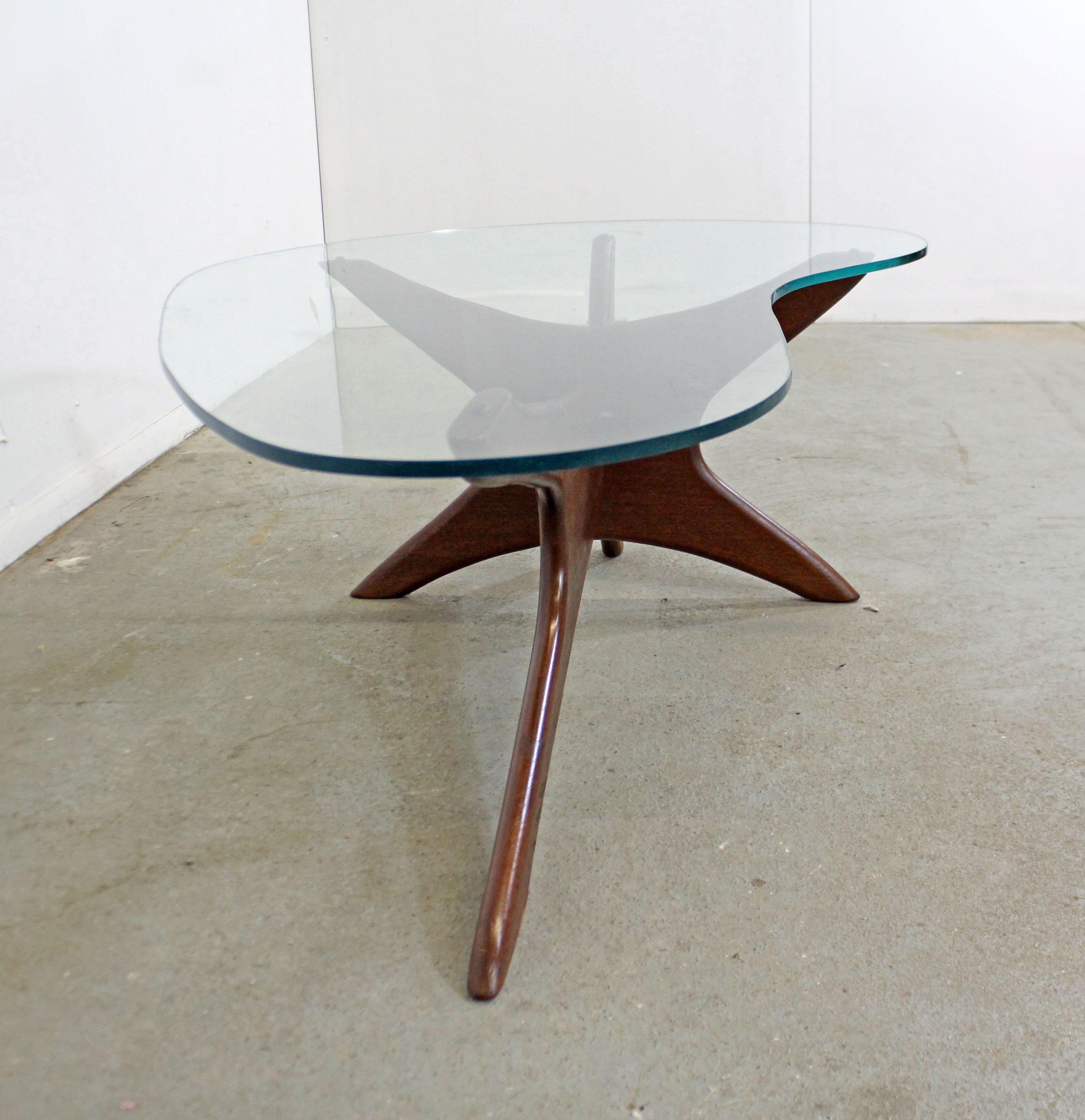 Offered is an authentic Adrian Pearsall 'Stingray' coffee table with a gorgeous sculptural wooden base and glass top. It was designed by Adrian Pearsall for Craft Associates. It is in good condition for its age, shows small chips and surface