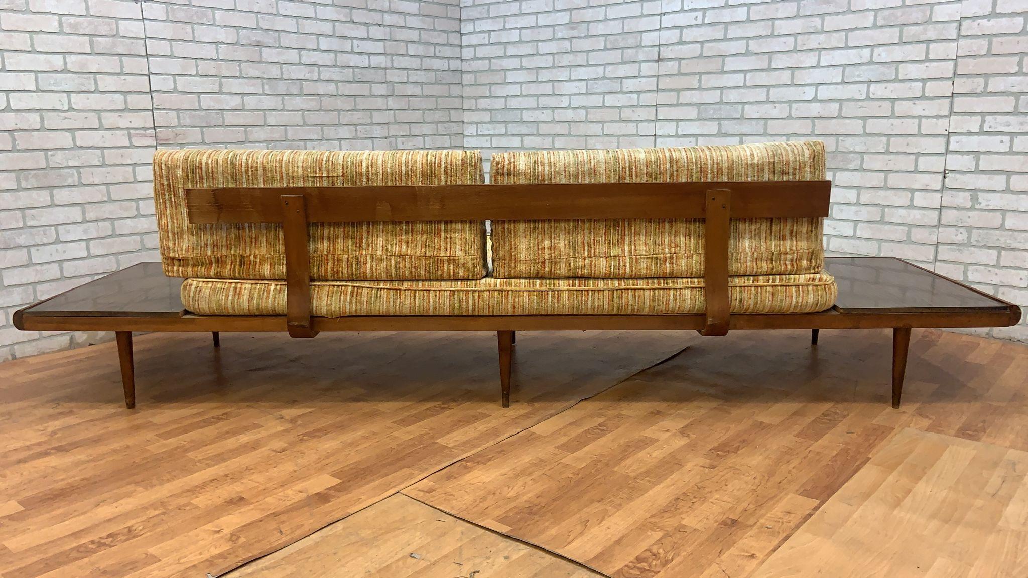 Mid Century Modern Adrian Pearsall Oak Daybed Sofa with Floating End Tables

This 20th Century Adrian Pearsall Oak Daybed Sofa has a built-in floating maple end tables extending like wings off the frame. The solid oak frame and support bands are in