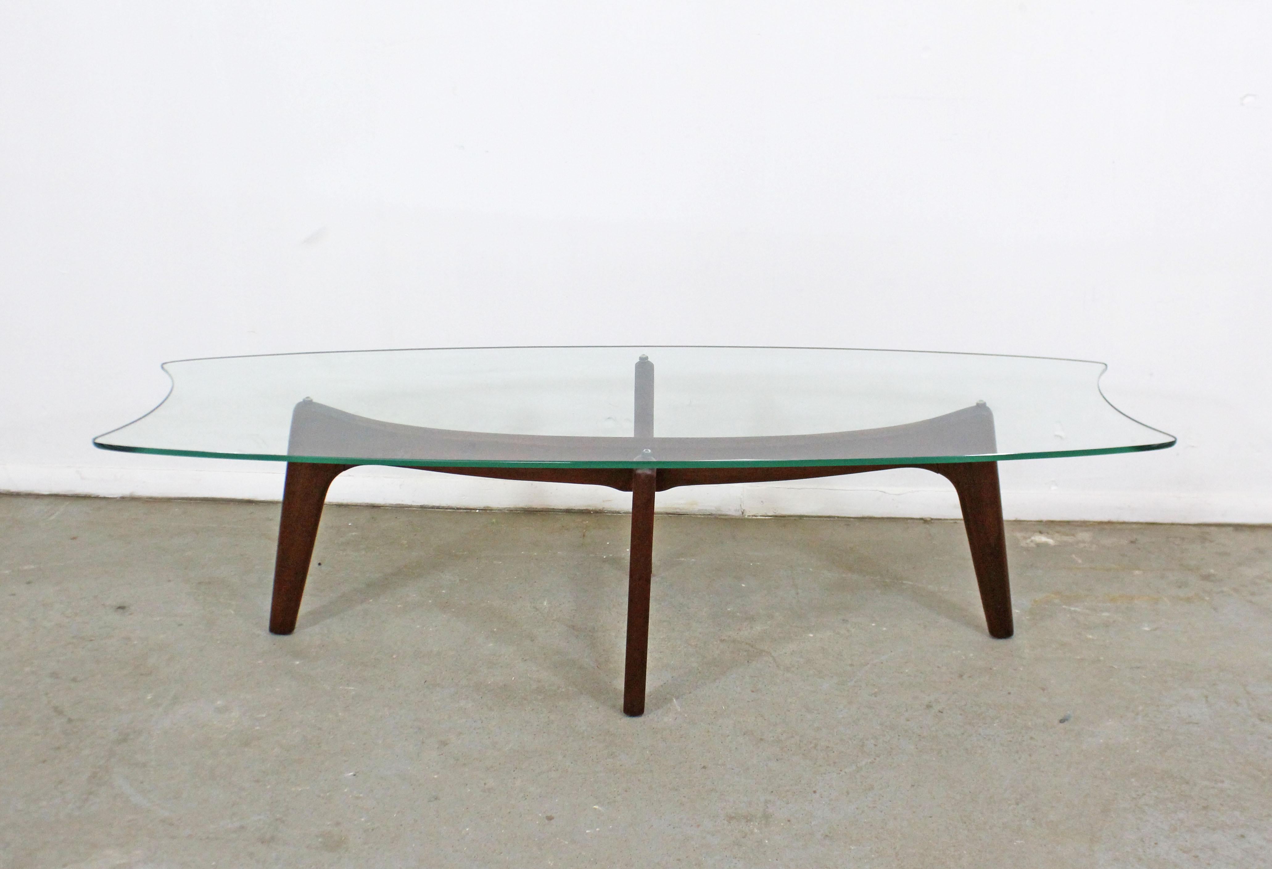 Offered is an authentic Adrian Pearsall 'Stingray' coffee table with a gorgeous sculptural wooden base and glass top. It was designed by Adrian Pearsall for Craft Associates. It is in good condition for its age, shows surface scratches on glass top