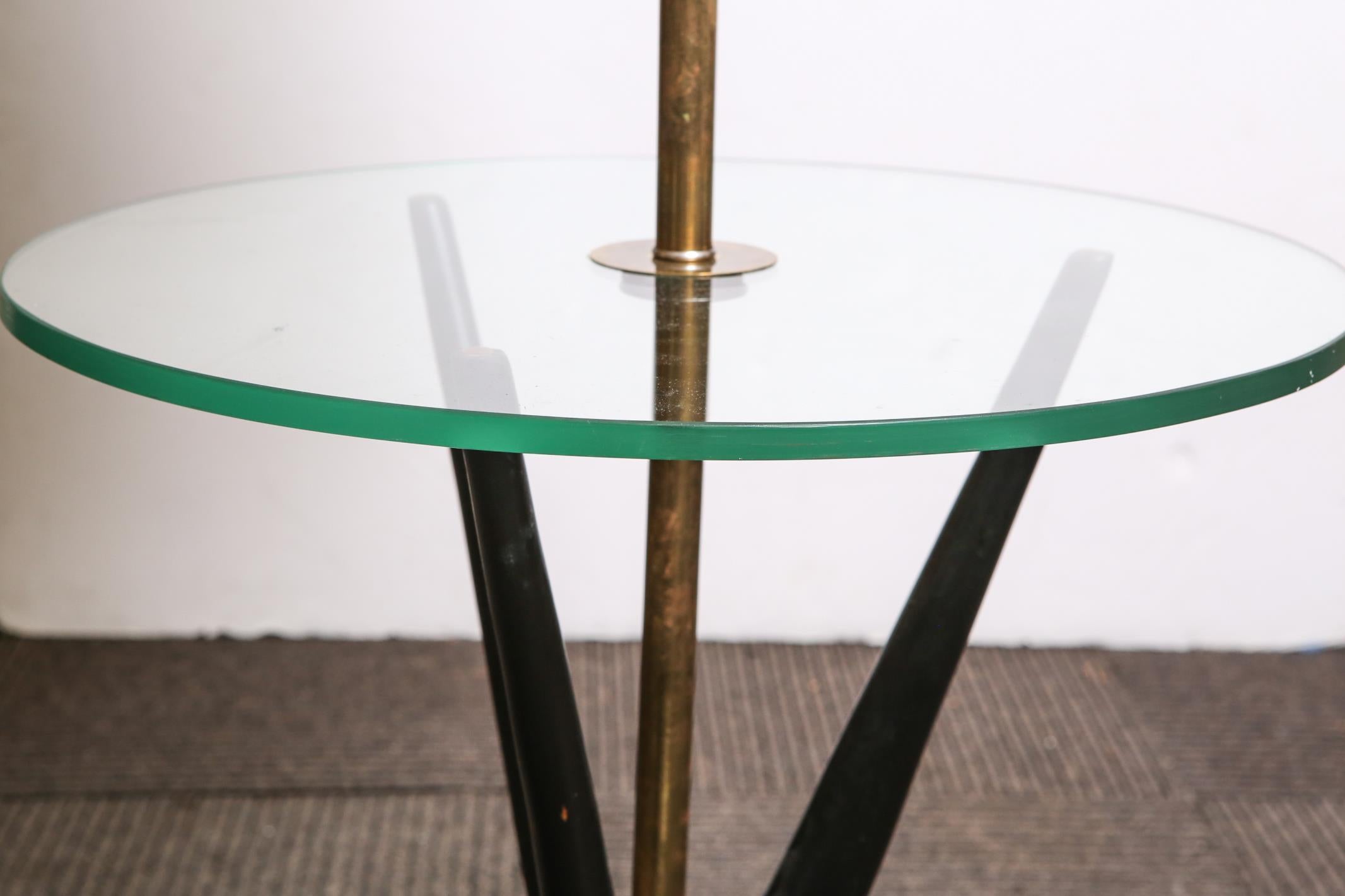Mid-Century Modern lamp table in the style of Adrian Pearsall, with hardwood frame with glass surface and fitted with a brass light fixture and shade. In great vintage condition with age-appropriate wear to the shade.