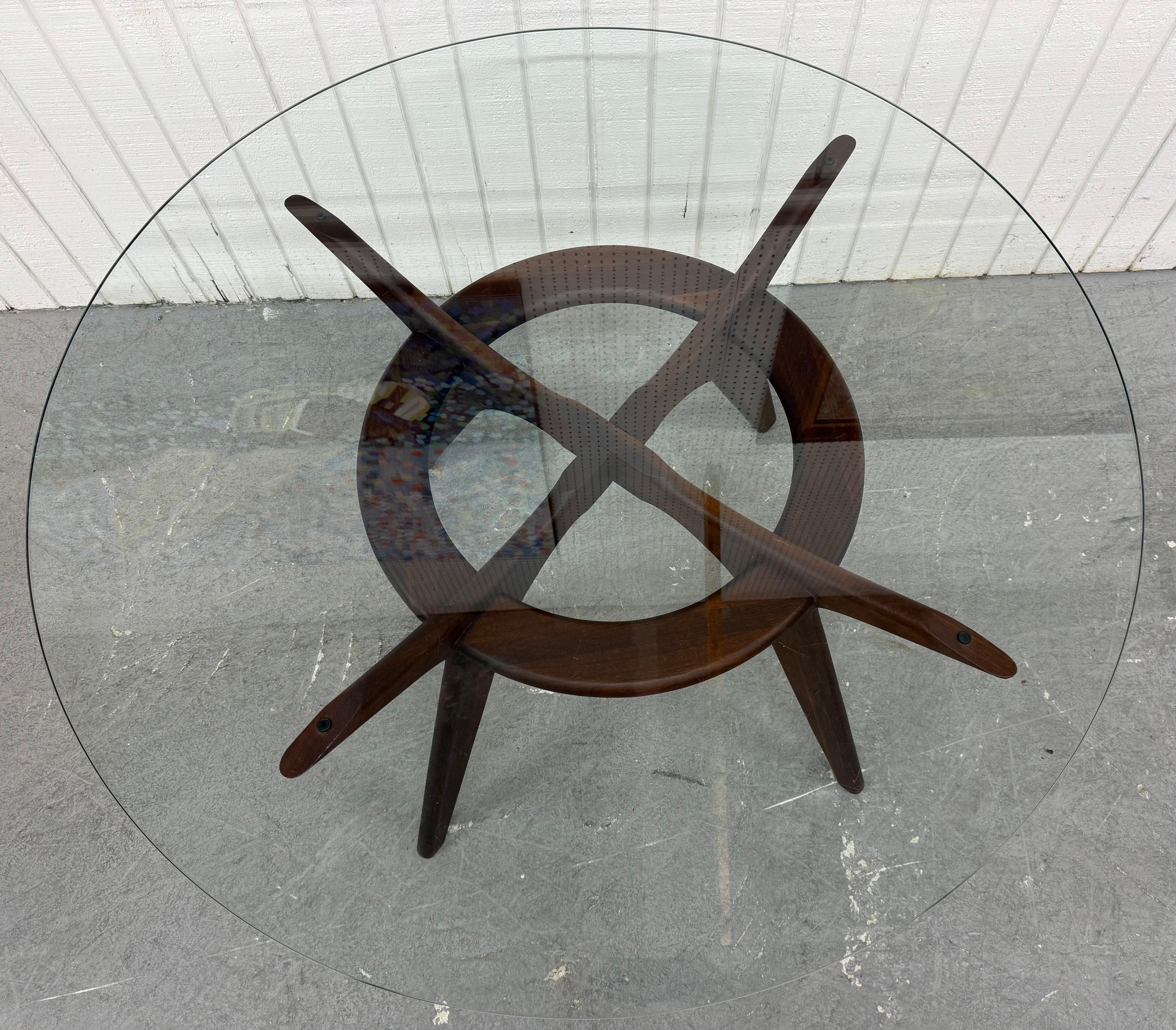 This listing is for a Mid-Century Modern Adrian Pearsall Walnut Glass Compass Dining Table. Featuring an original round glass top, solid wood compass style base, and a beautiful dark walnut finish. This is an exceptional combination of quality and