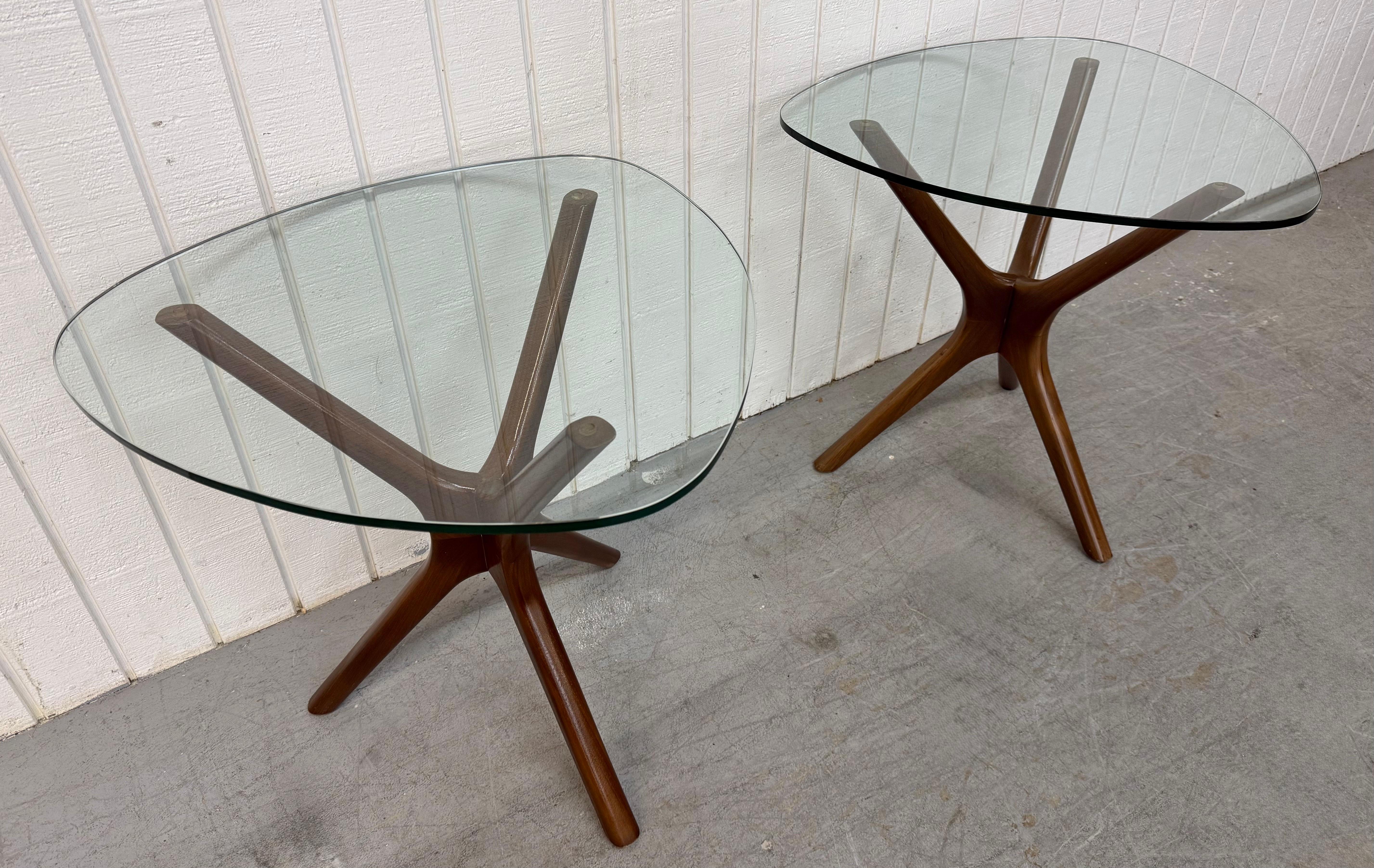 This listing is for a pair of Mid-Century Modern Adrian Pearsall Walnut Glass Top Side Tables. Featuring a solid wood walnut table base, jax style design, and original glass tops. This is an exceptional combination of quality and MCM design by