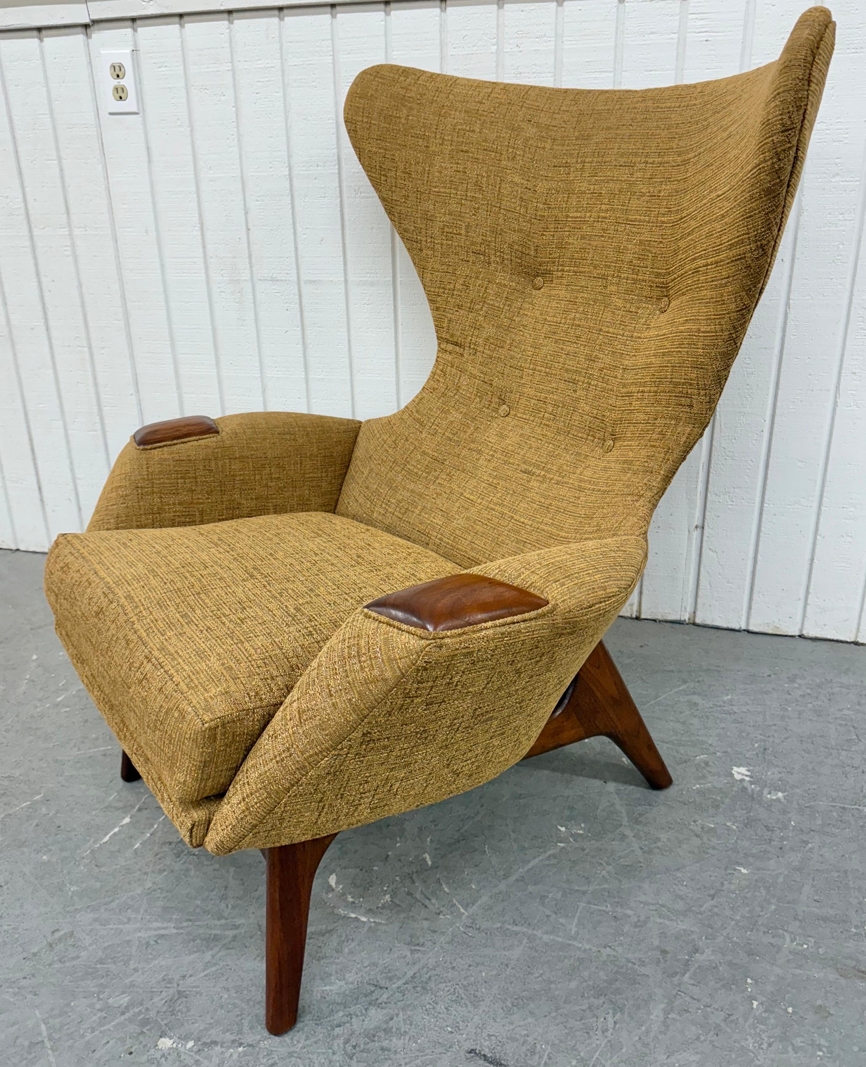 This listing is for a rare Mid-Century Modern Adrian Pearsall Wing Chair & Ottoman. Featuring a large rounded back wing chair design, arms with walnut accents, modern walnut legs, matching ottoman, and new golden upholstery. This is an exceptional