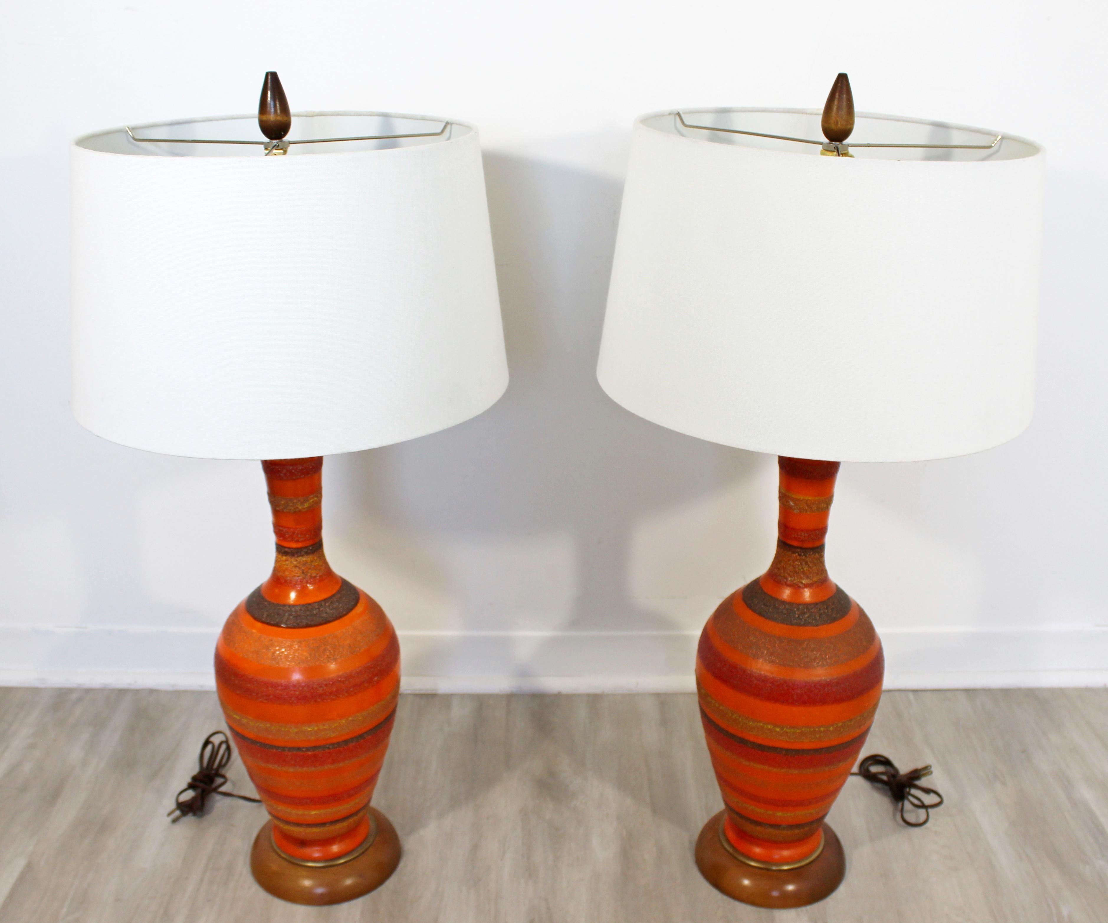 For your consideration is a stunningly vibrant pair of striped, ceramic table lamps, with wood finials, by Aldo Londi for Bitossi, made in Italy, circa 1960s. In excellent vintage condition. The dimensions of the lamps are 7