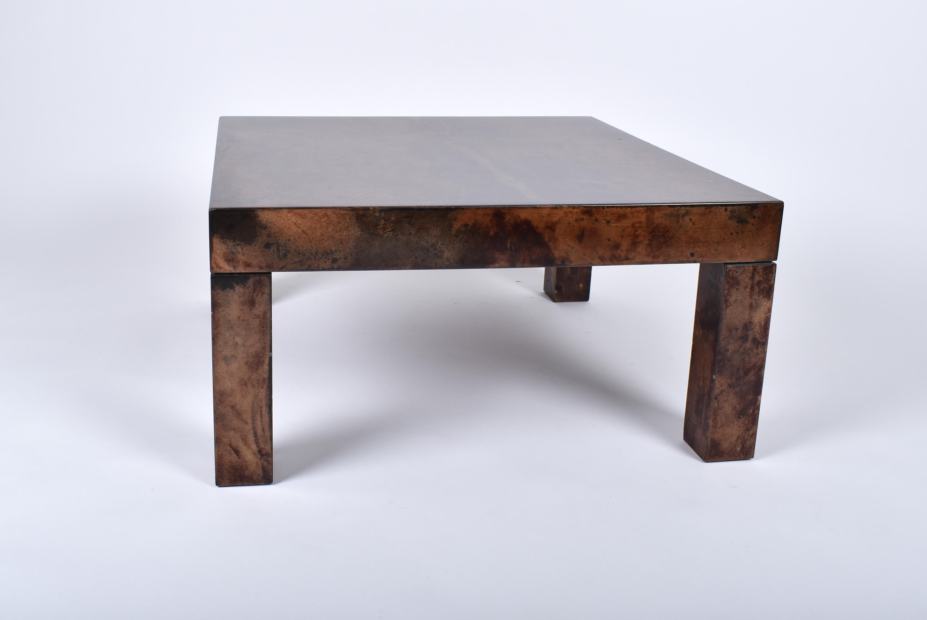 Square coffee table by Aldo Tura.
Distinctive use of goatskin layered with a high gloss varnish.
Good original condition, beautiful shade.
  