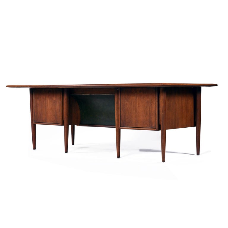 Mid-Century Modern walnut and mahogany executive desk. American made by Alma, from their “Castilian” collection. This is the Cadillac of desks — a piece that would make even Don Draper envious! Atypically large with a beautiful mahogany top resting