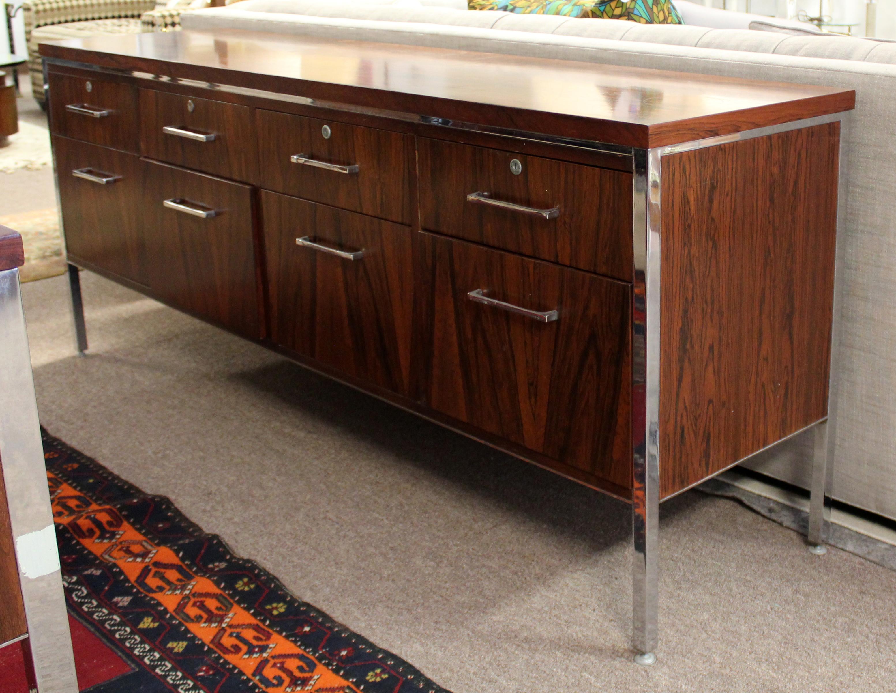 For your consideration is a phenomenal, executive desk and credenza file cabinet, made of rosewood, with filing drawers, by Alma Desk Company, circa 1960s. In fair vintage condition. The dimensions of the credenza are 72