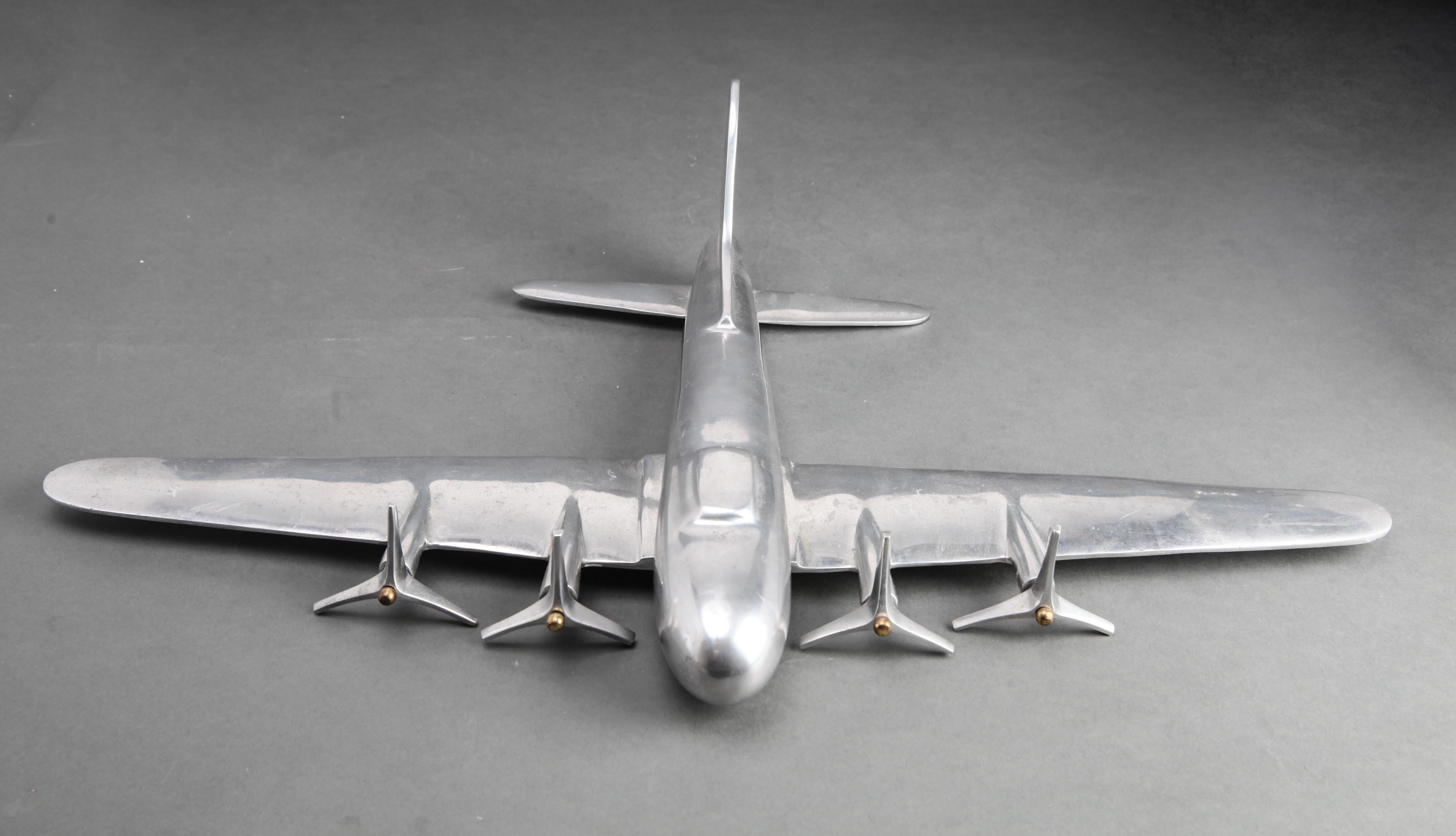 Mid-Century Modern aluminum airplane model sculpture. The piece has four aluminum propellers that can rotate. Comes without stand. In great vintage condition with age-appropriate wear and use.