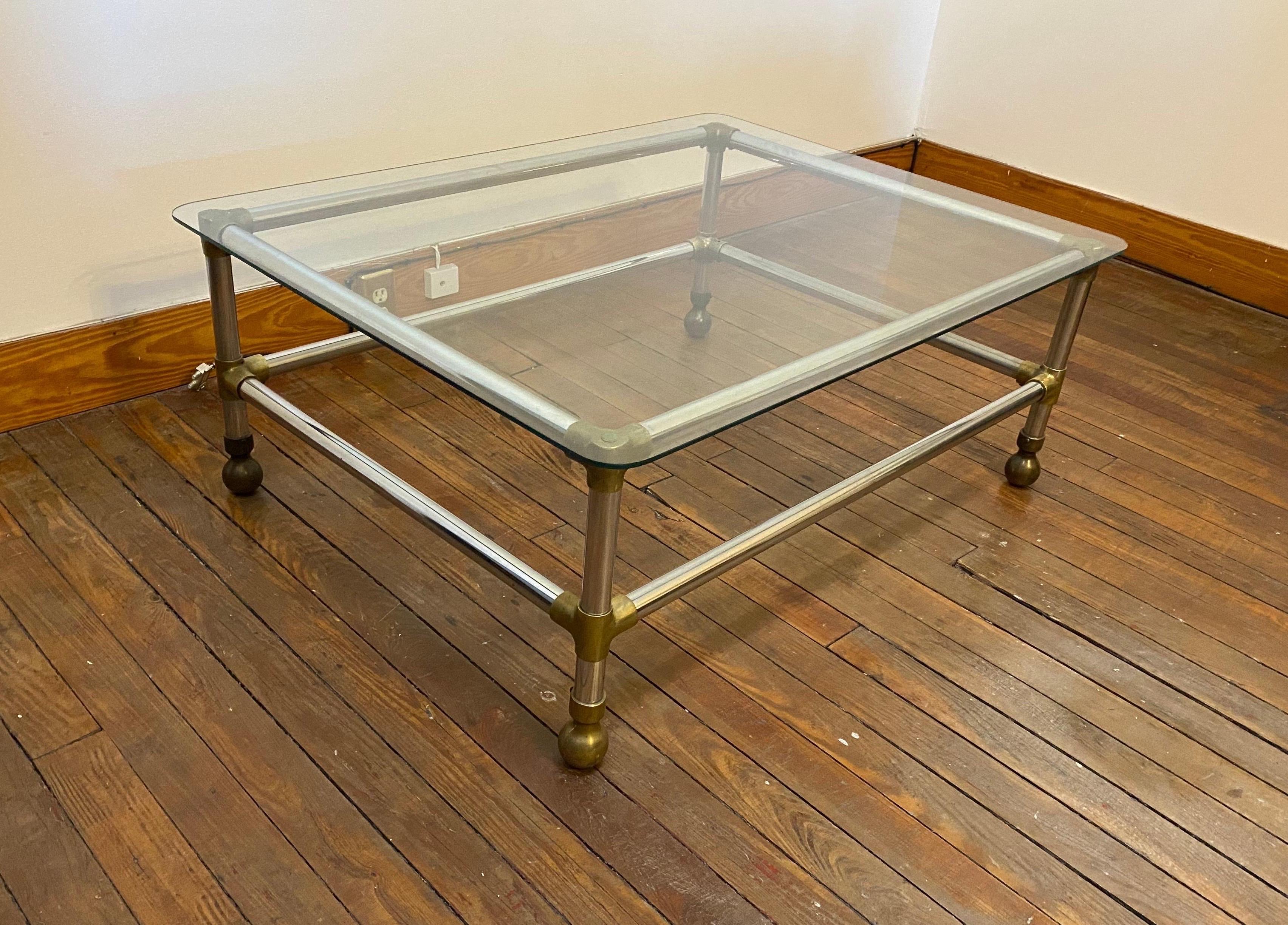 Great midcentury/modern aluminum, brass and glass coffee table.