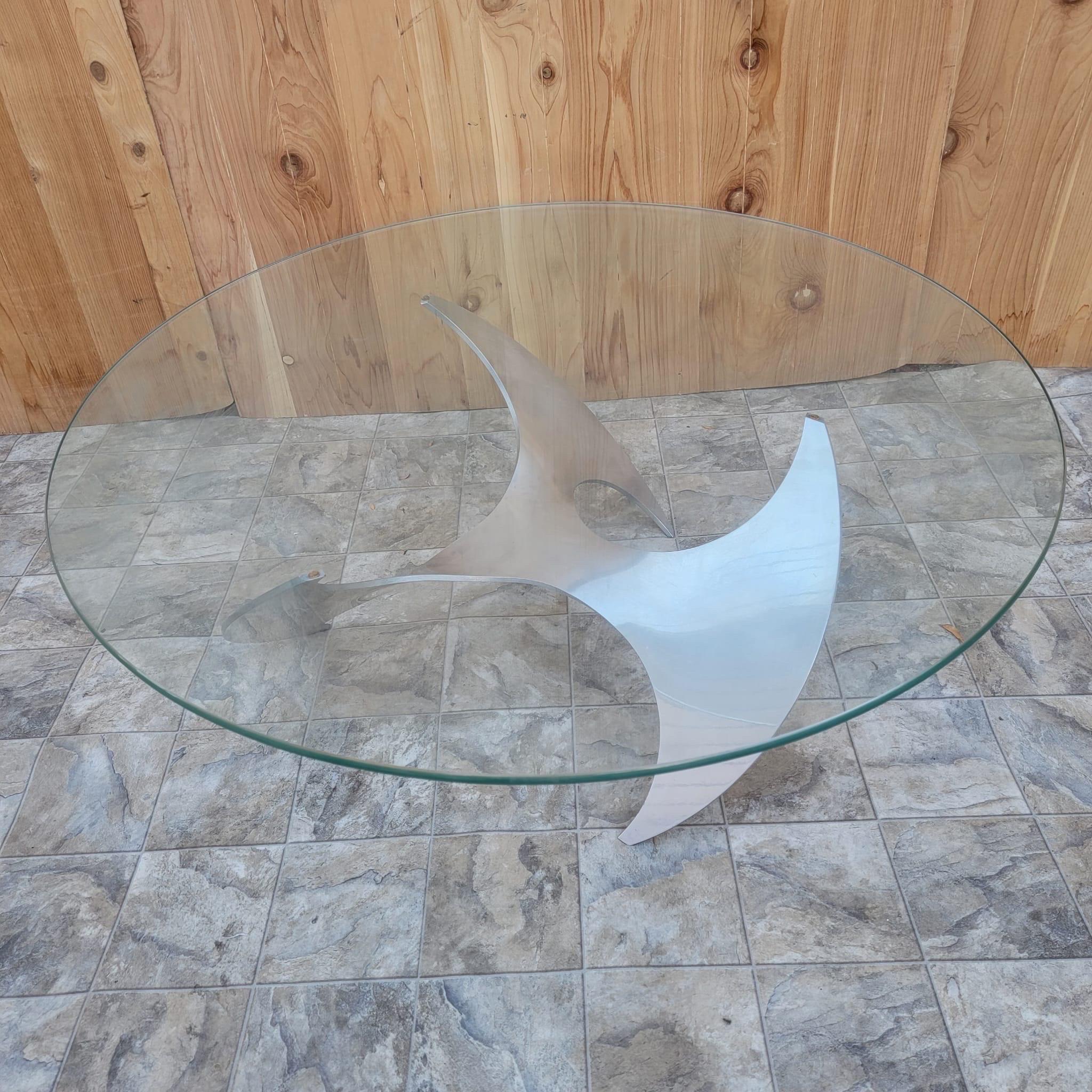Vintage Industrial Aluminum Propeller coffee table by Knut Hesterberg

Classic mid century modern German propeller coffee table by Knut Hesterberg for Ronald Schmitt featuring a sculptural polished aluminum propeller-form base with a glass top.