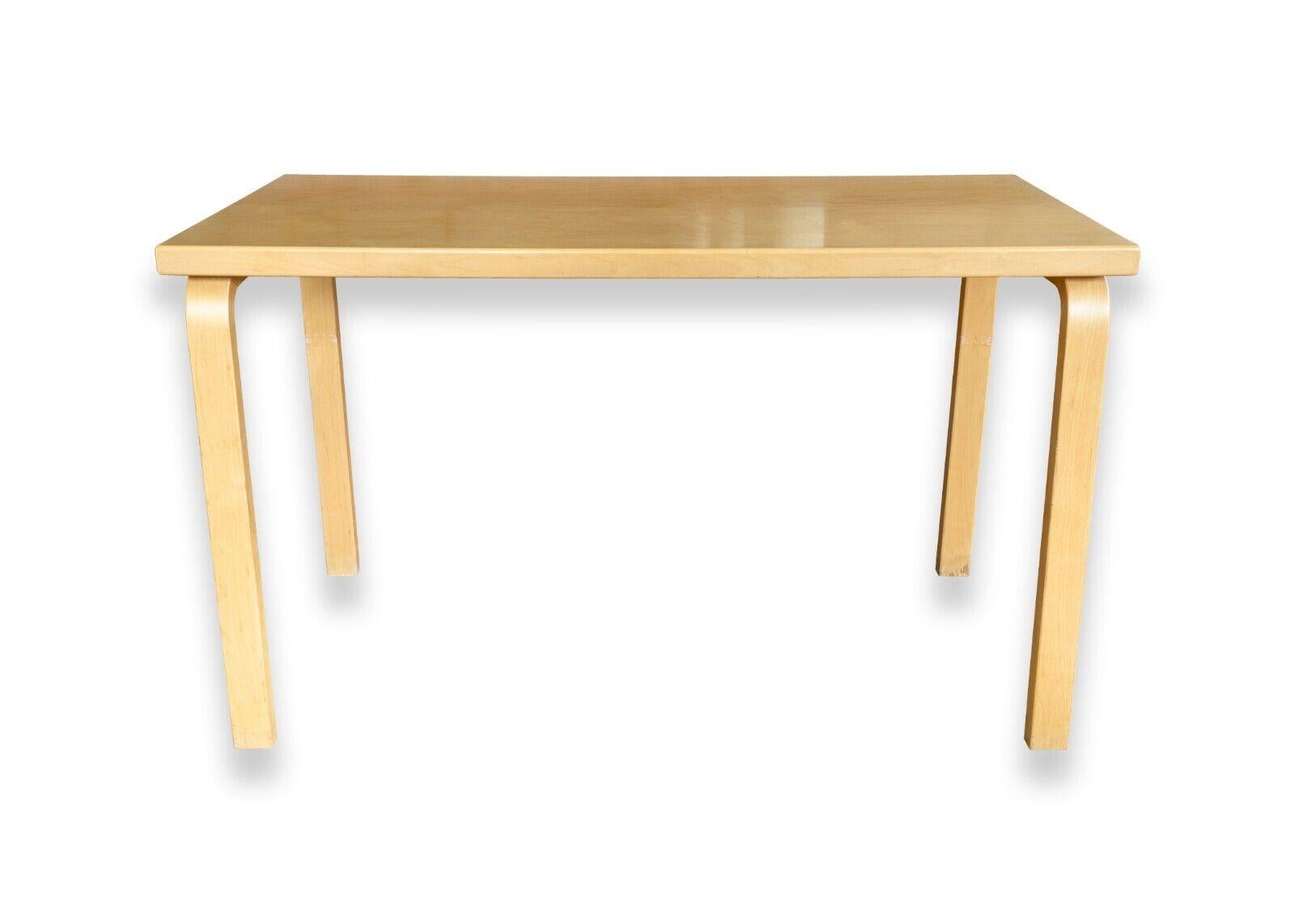 A Alvar Aalto 81B birch desk table for ICF. This lovely little accent table features a very simple, but stunning design featuring an all birch wood construction and a lacquered finish. The simplicity of this table is where it shines. The four legs