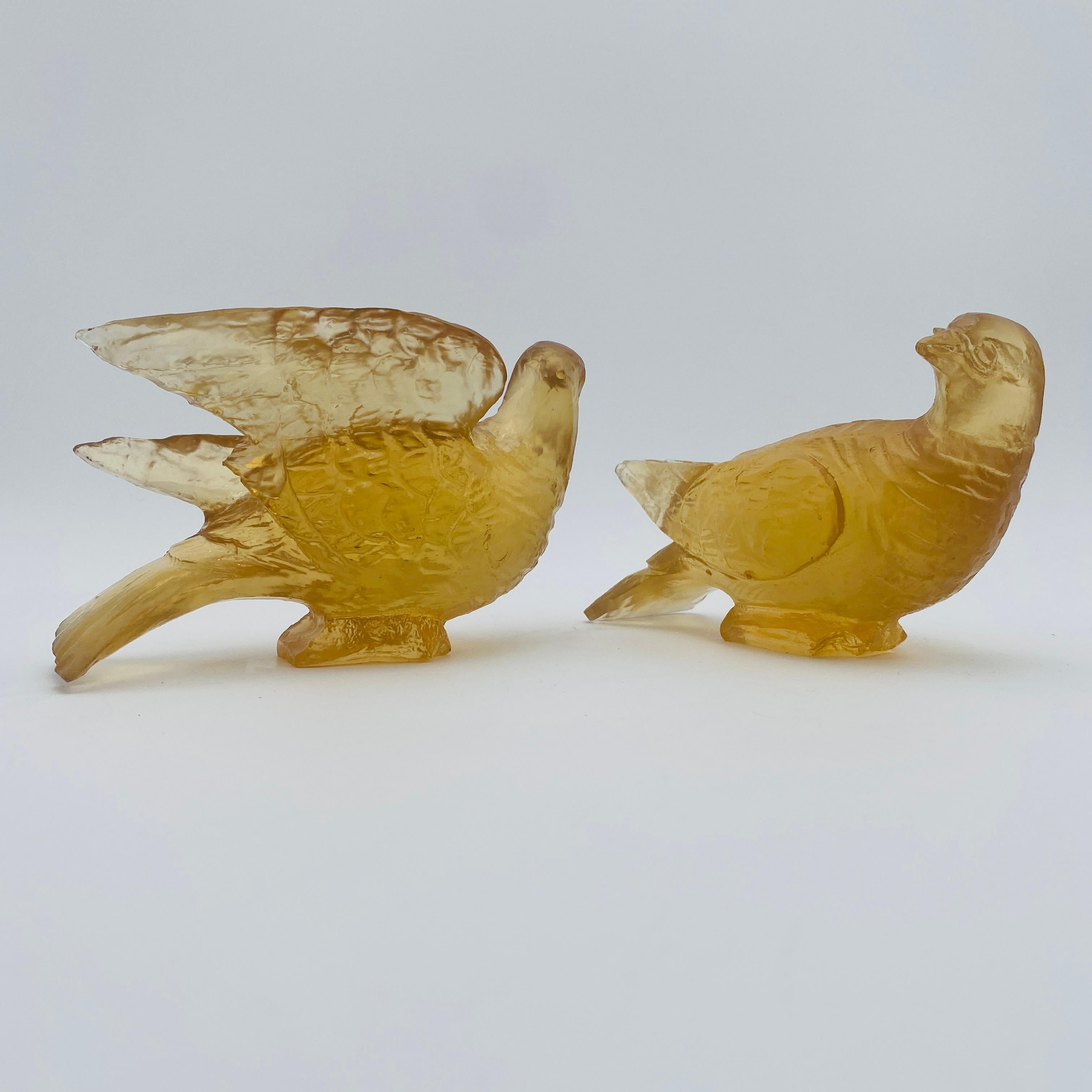 This is an Amber resin bird sculpture, specifically doves, by Dorothy Thorpe made circa the 1970s. The sculpture is perfectly translucent which makes the birds glow in the light! 