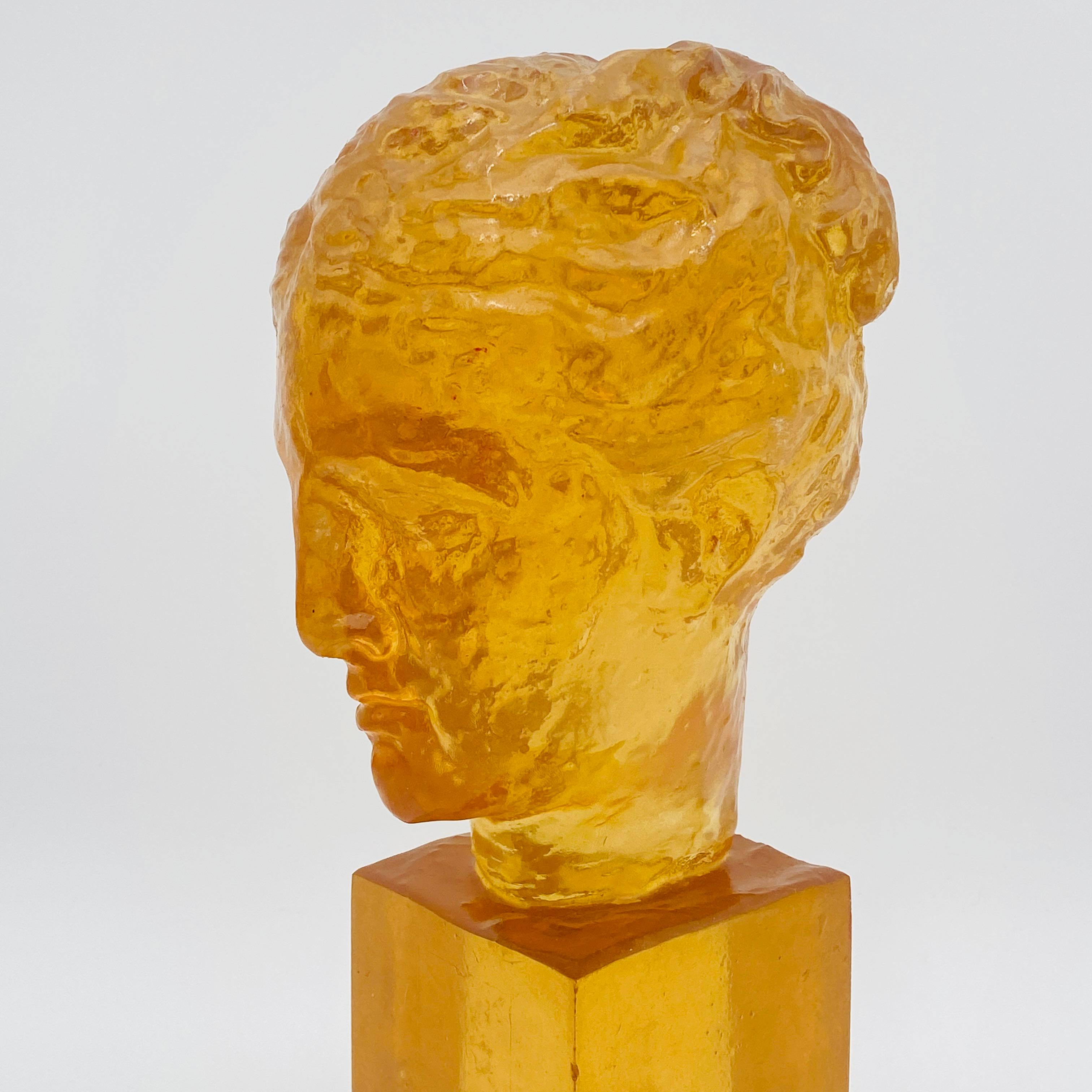 This is an Amber resin bust of classical sculpture by Dorothy Thorpe made circa the 1970s. The sculpture is perfectly translucent which makes the bust glow! 