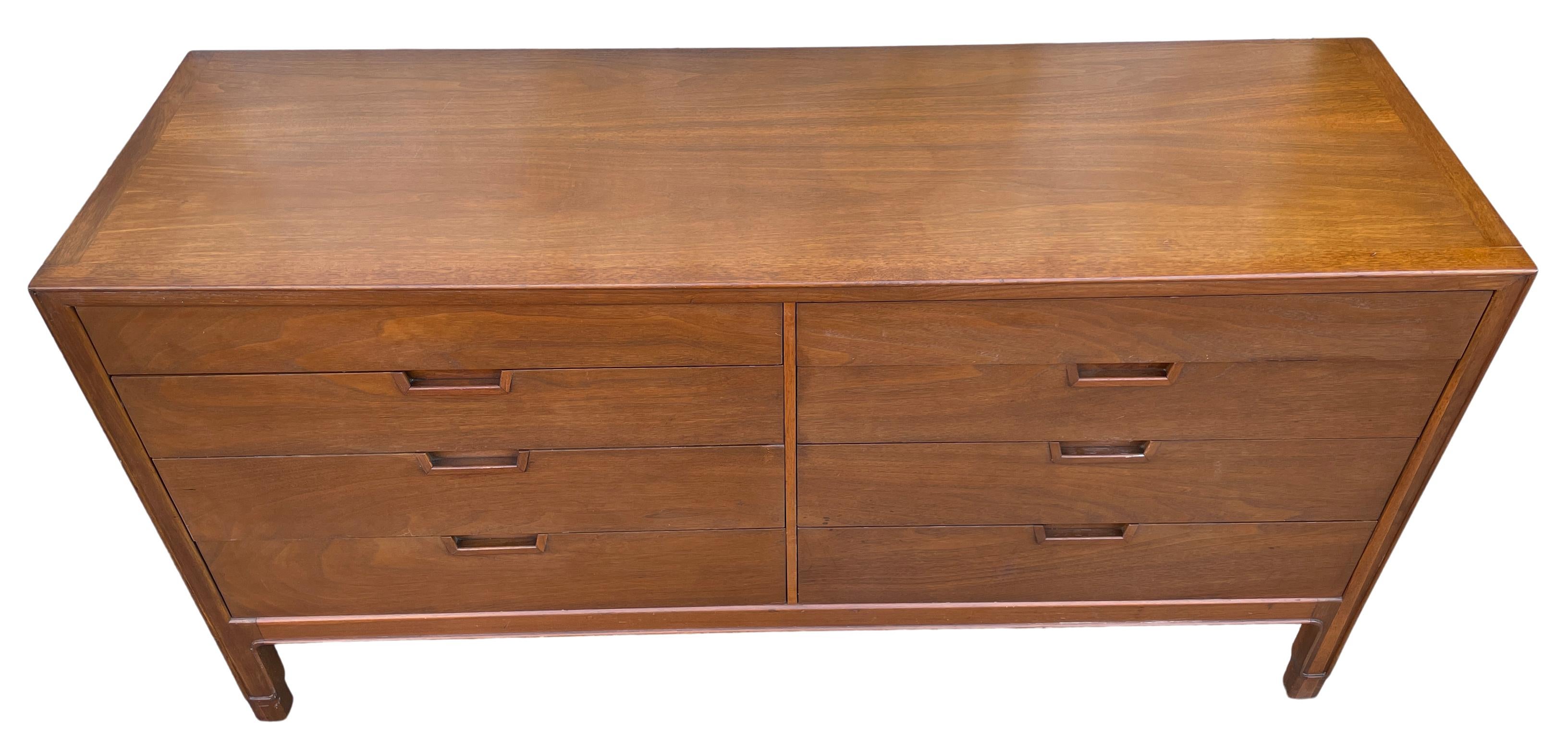 Mid-Century Modern American 8 drawer dresser by Janus. Great walnut 8 drawer dresser - solid wood construction. Beautiful Carved handles all drawers slide smooth - clean inside and out. Great American Designed Dresser. Located In Brooklyn NYC.