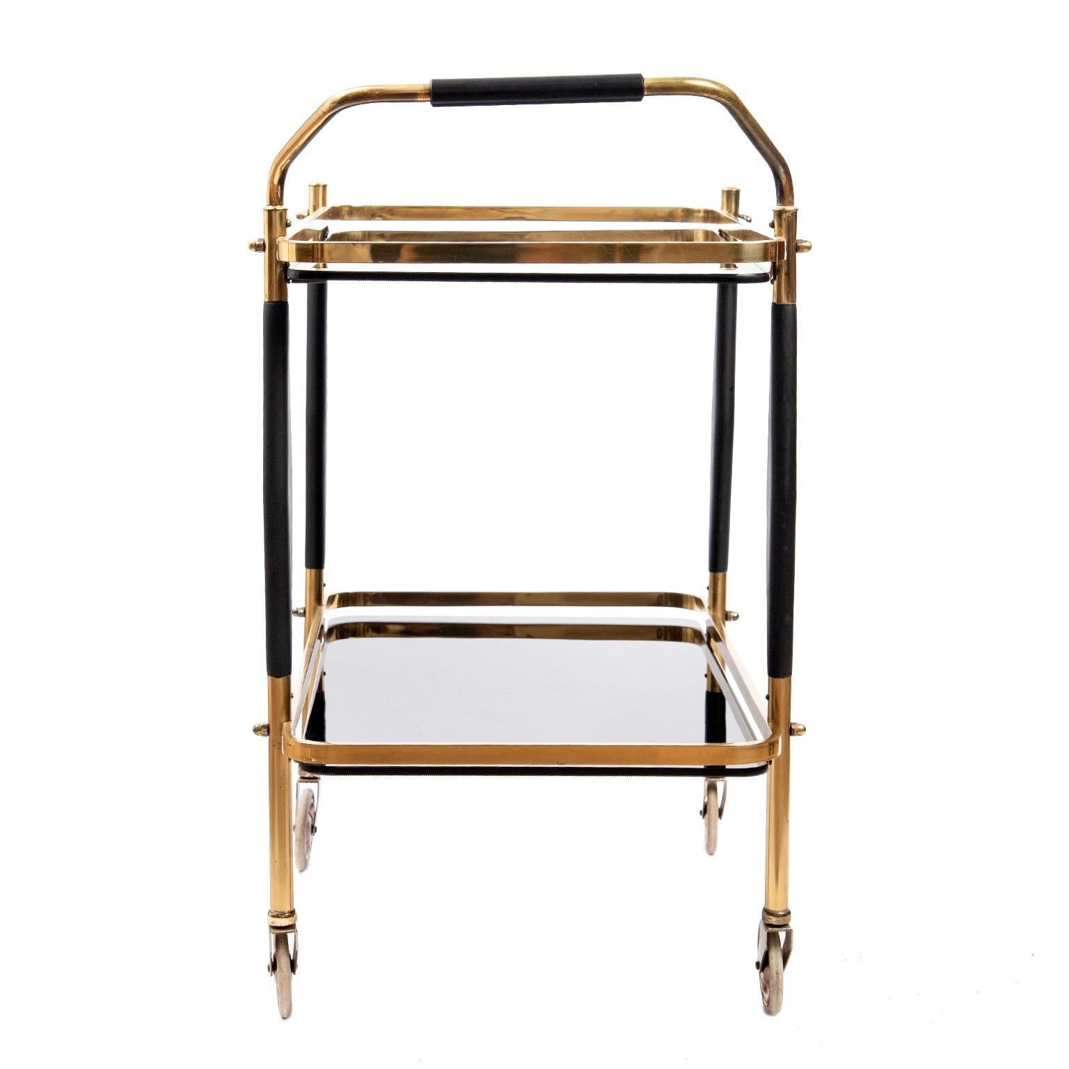 A little gem is how I would describe this vintage 1950s brass bar cart with original solid 