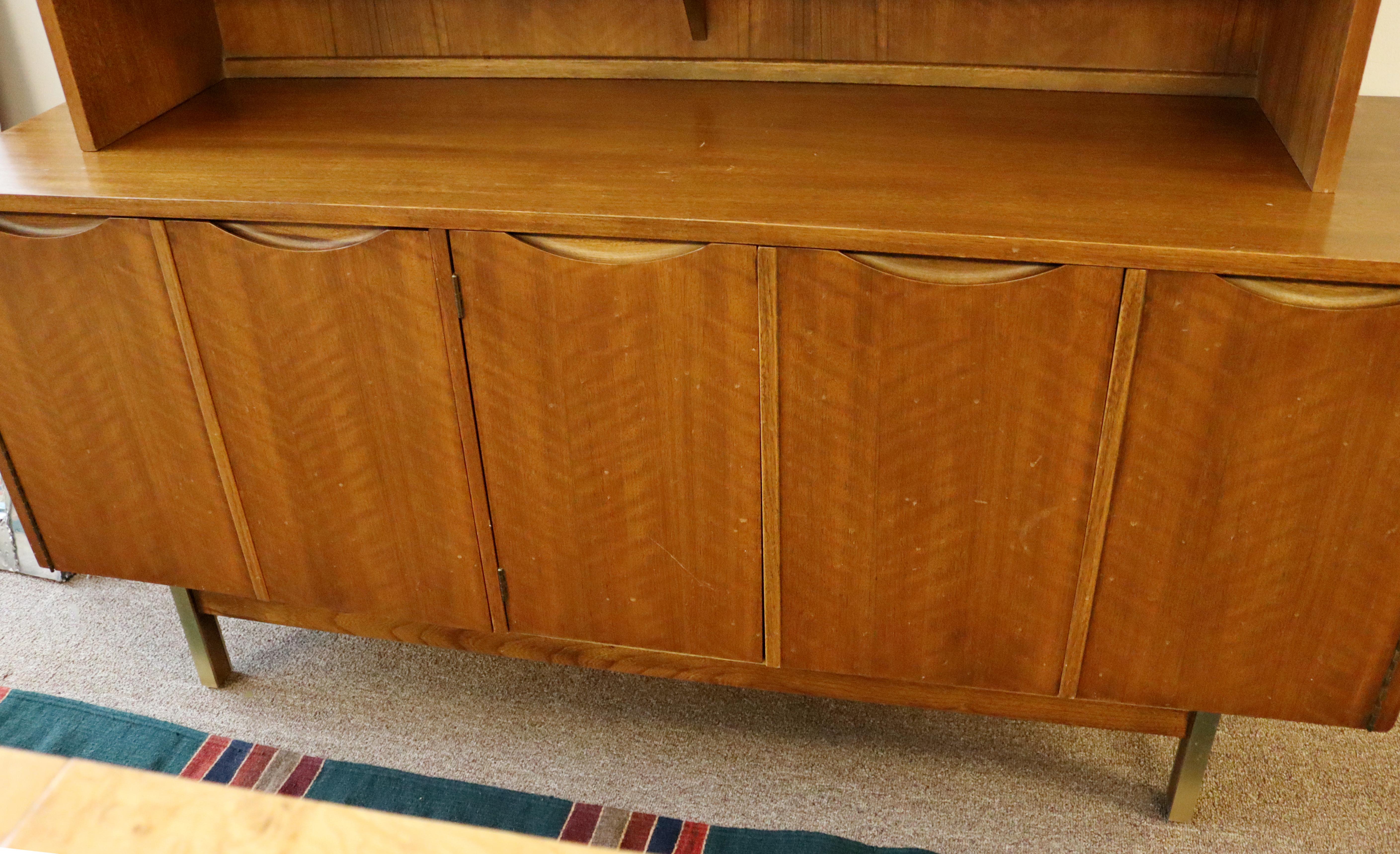 For your consideration is a magnificent, two piece, walnut wood credenza, and a hutch with sliding glass doors, by American of Martinsville, circa the 1960s. In excellent vintage condition. The dimensions are 64