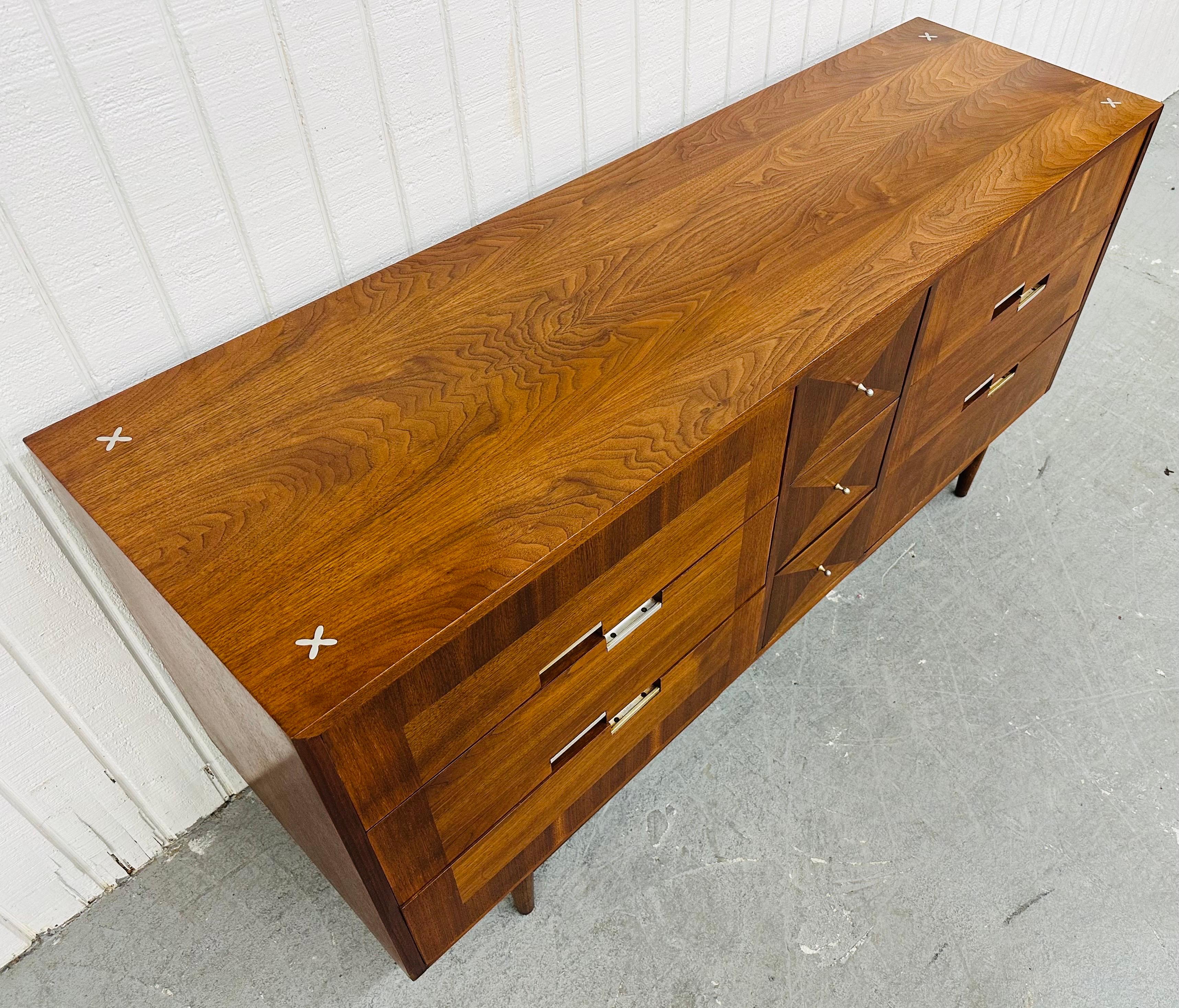 This listing is for a Mid-Century Modern American of Martinsville Accord 9-Drawer Dresser. Featuring a straight line design, six large drawers on each side, three smaller drawers in the middle, modern legs, chrome pulls, and a beautiful walnut