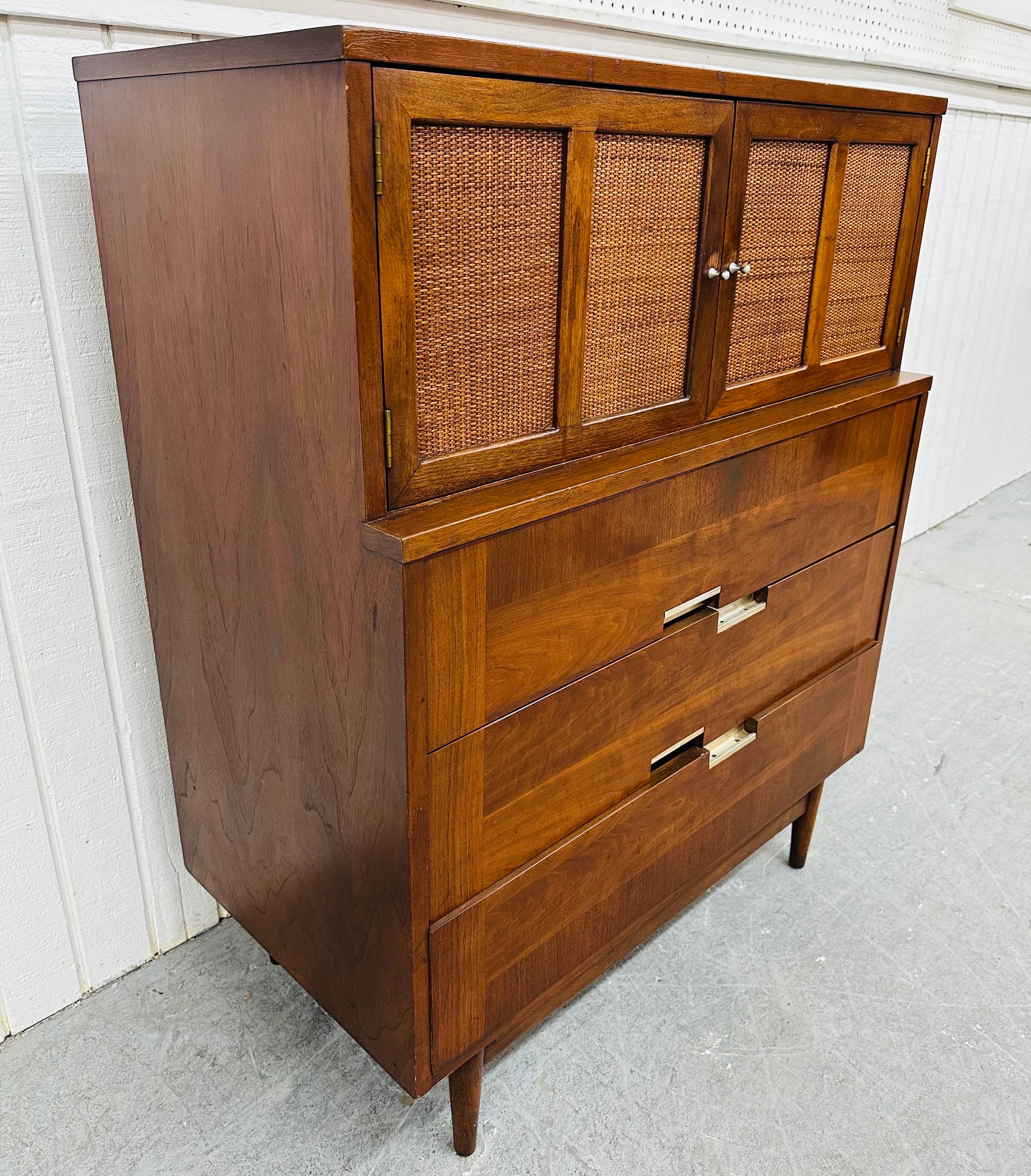 This listing is for a Mid-Century Modern American of Martinsville Accord Walnut High Chest. Featuring a straight line design, two cane doors that open up to two hidden drawers, three large bottom drawers with chrome pulls, modern legs, and a