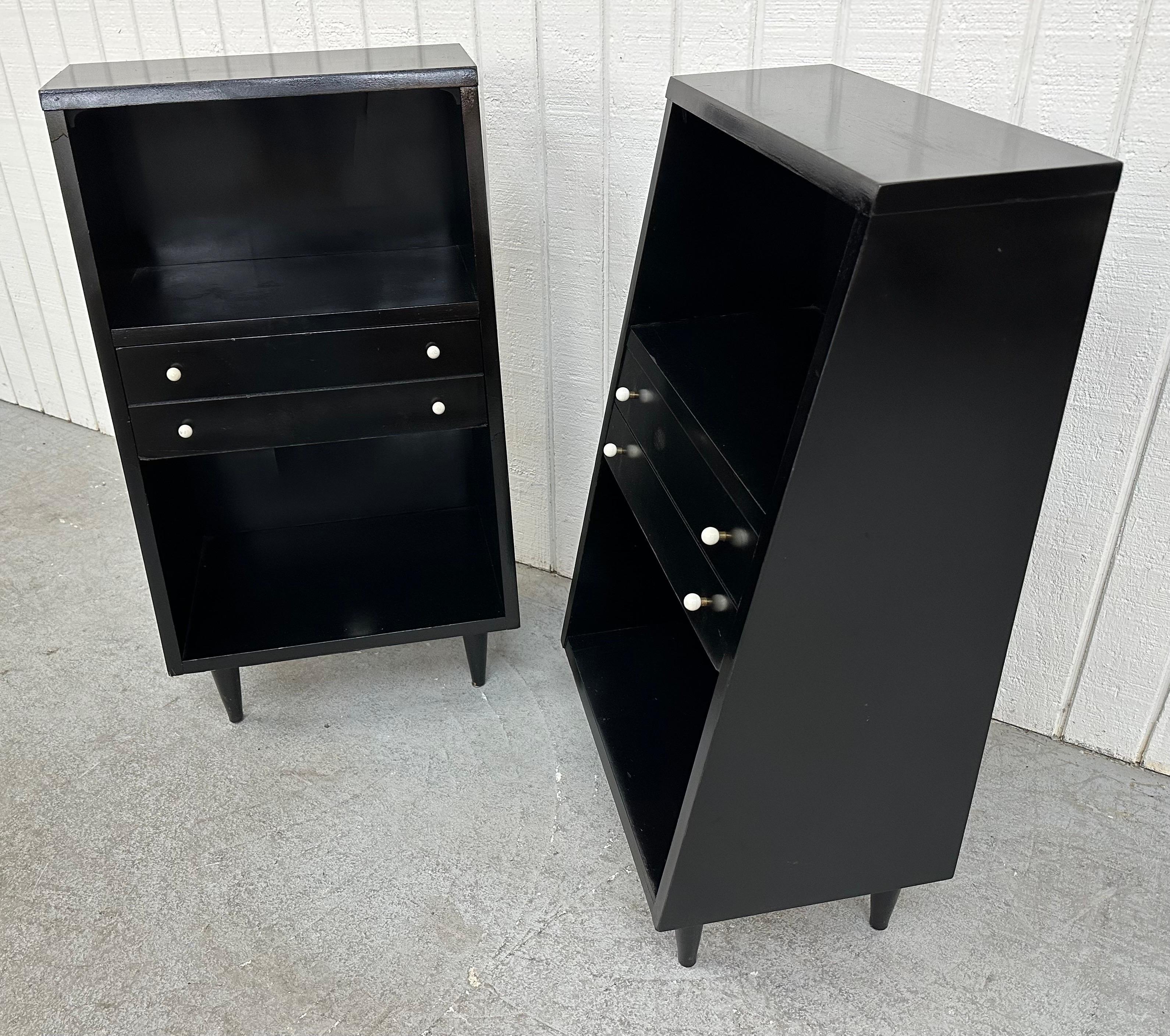 This listing is for a pair of Mid-Century Modern American of Martinsville Black Lacquered Nightstands. Featuring a straight line design, single drawer for storage, original white knobs, and original black finish. This is an exceptional combination