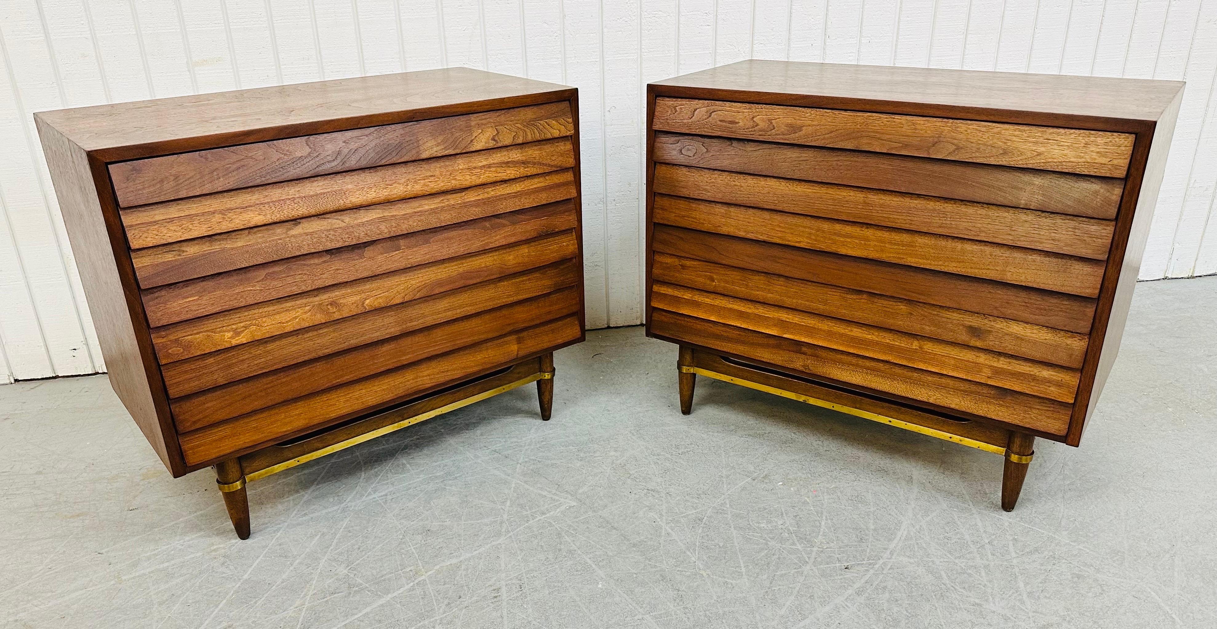 This listing is for a pair of Mid-Century Modern American of Martinsville Dania Walnut Bachelor Chests. Featuring a straight line design with louvered front drawers, three drawers for storage, modern legs with a brass stretcher, and a beautiful