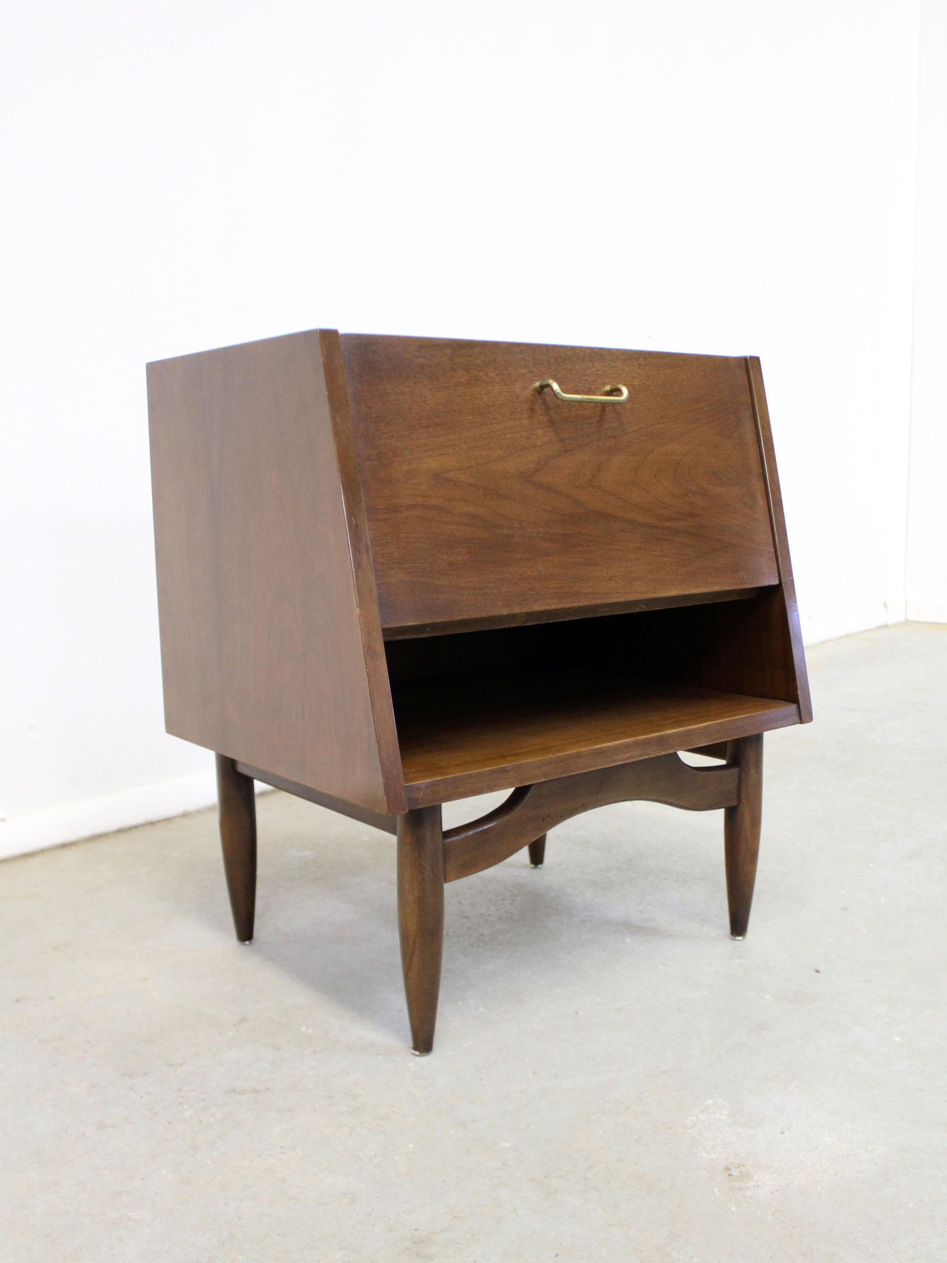 Offered is a walnut nightstand, designed by Merton L. Gershun for American of Martinsville's 