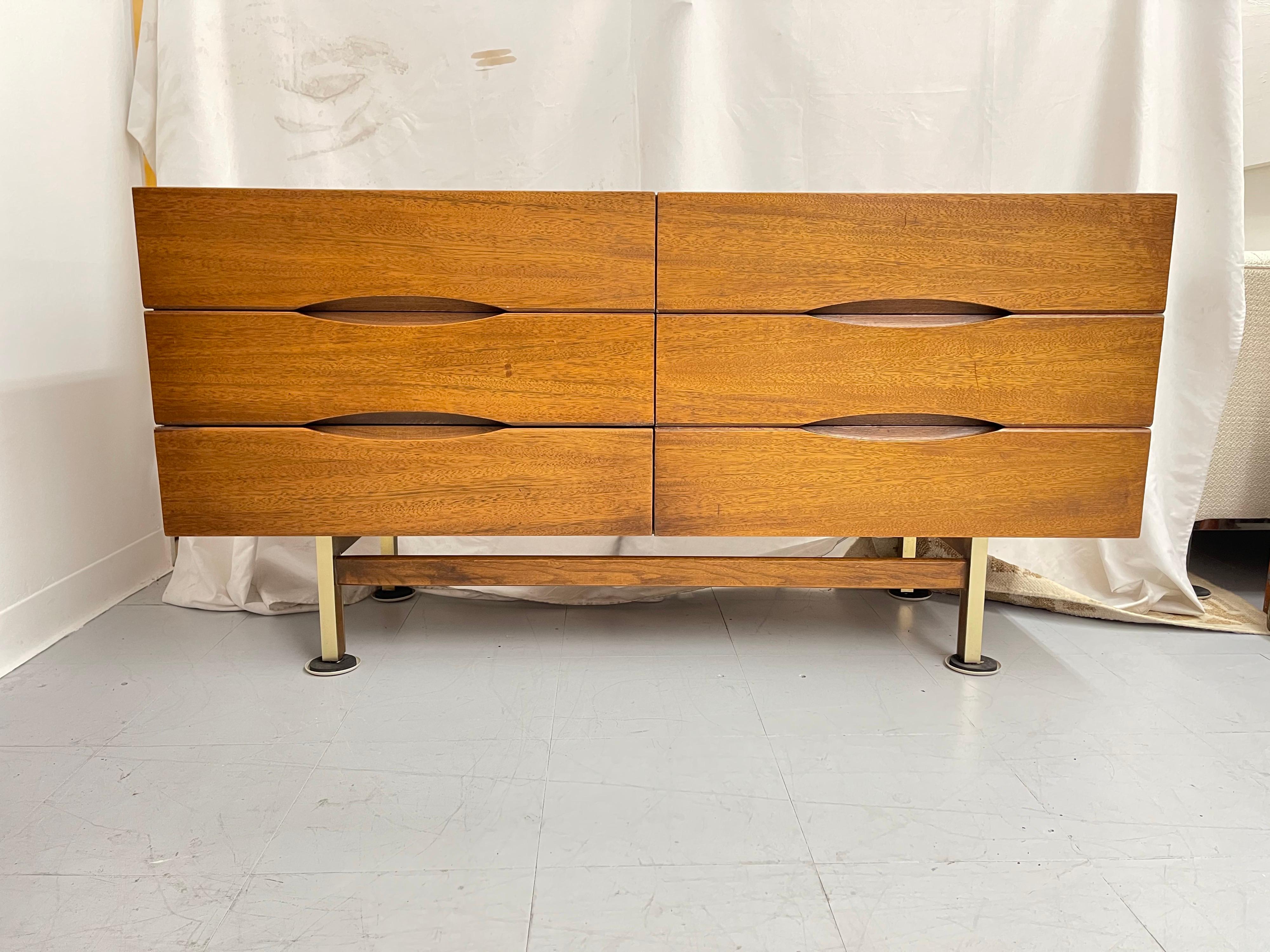 Clean lined six-drawer dresser form American of Martinsville. Elliptical inset drawer openings and four brass-clad mahogany deeply recessed legs with high set mahogany stretchers.