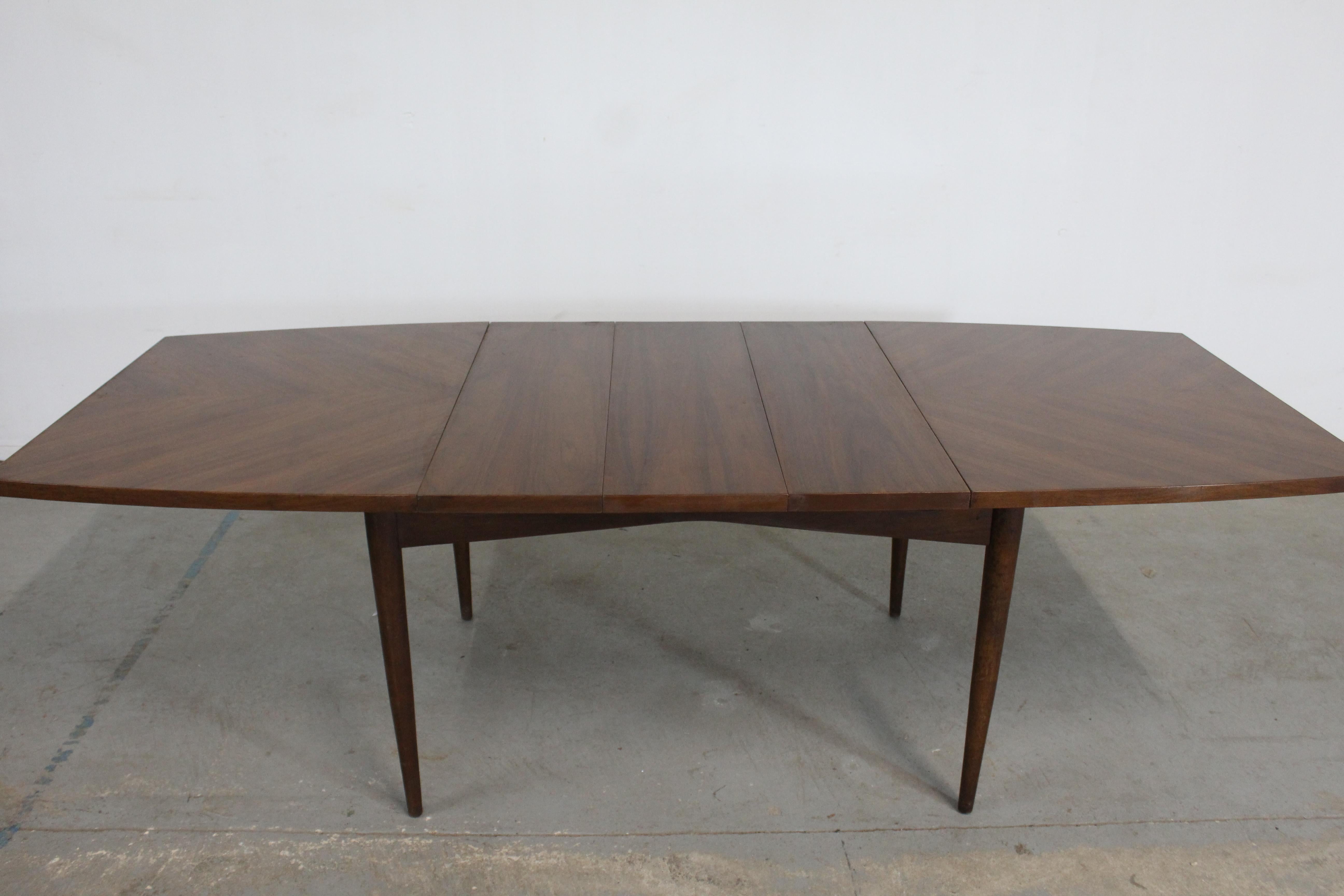 Mid-Century Modern American of Martinsville surfboard walnut dining table w 3 extensions
Offered is a Mid-Century Modern surfboard walnut dining table w 3 extensions. The table is by American of Martinsville. This table is prefect for city living