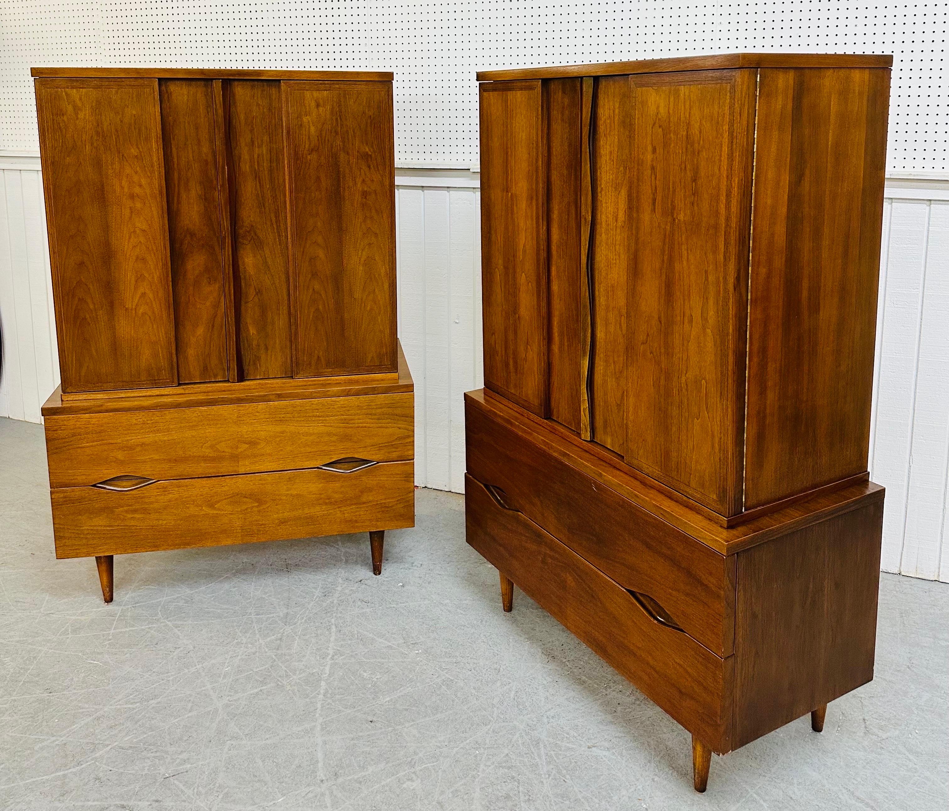 This listing is for a pair of Mid-Century Modern American of Martinsville Walnut Armoires. Featuring a straight line design, two doors that open up to storage space and three large hidden drawers, two more large drawers at the bottom, and a