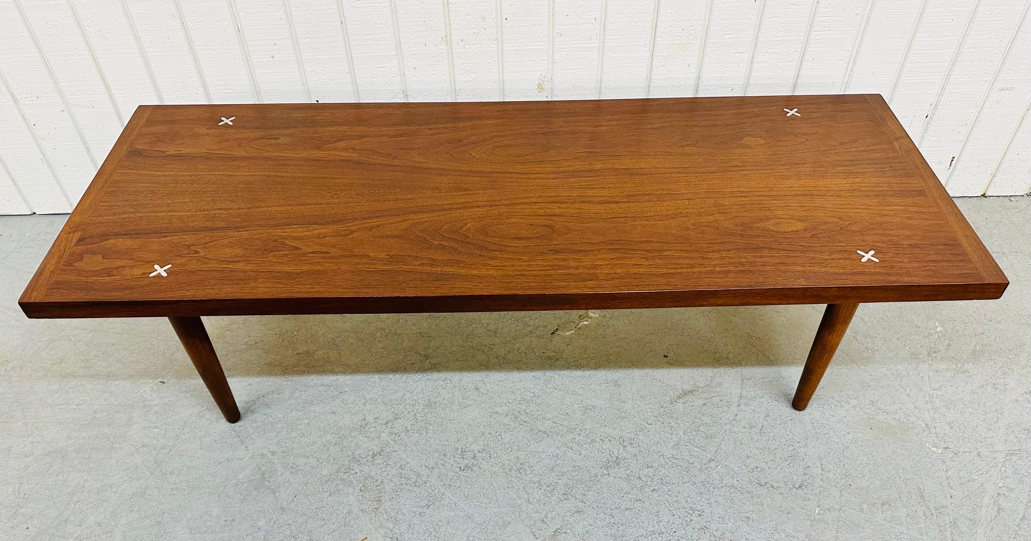 This listing is for a Mid-Century Modern American of Martinsville Walnut Coffee Table. Featuring a thick rectangular walnut top, inlaid silver cross at each corner, and four removable legs. This is an exceptional combination of quality and design by