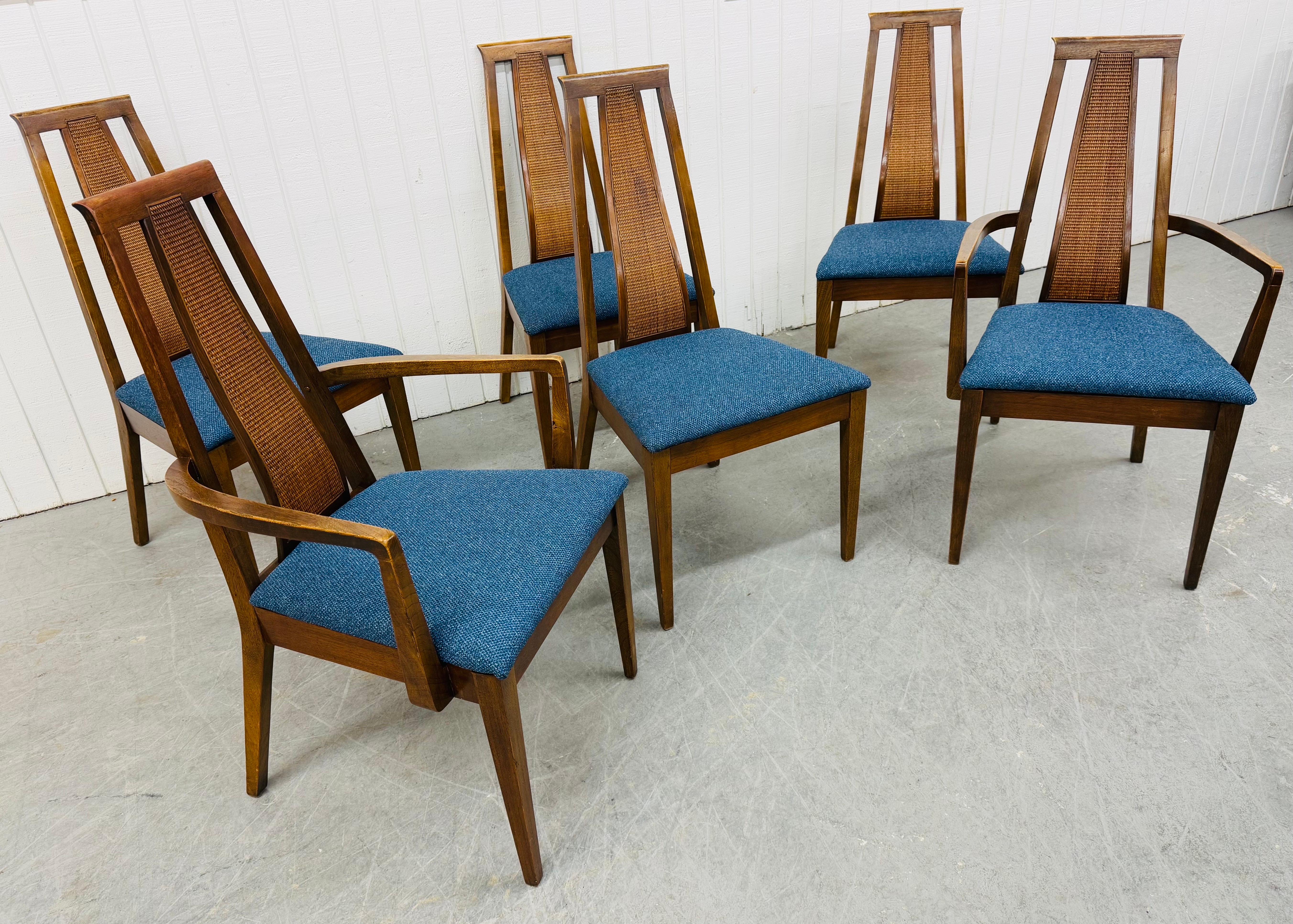 This listing is for a set of six Mid-Century Modern American of Martinsville Walnut Dining Chairs. Featuring a high caned back design, two arm chairs, four side chairs, new navy blue upholstery, modern legs, and a walnut finish. This is an
