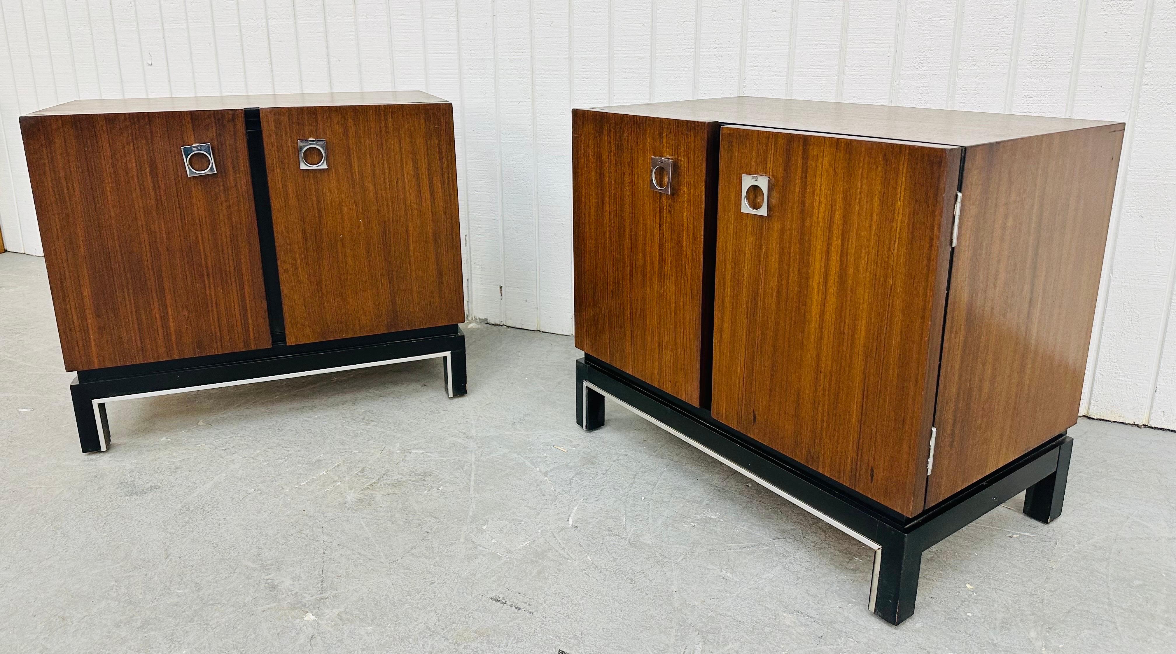 This listing is for a pair of Mid-Century Modern American of Martinsville Walnut Nightstands. Featuring a straight line design, two doors with chrome hardware that open up to a hidden drawer, storage space, black modern legs, and a beautiful walnut