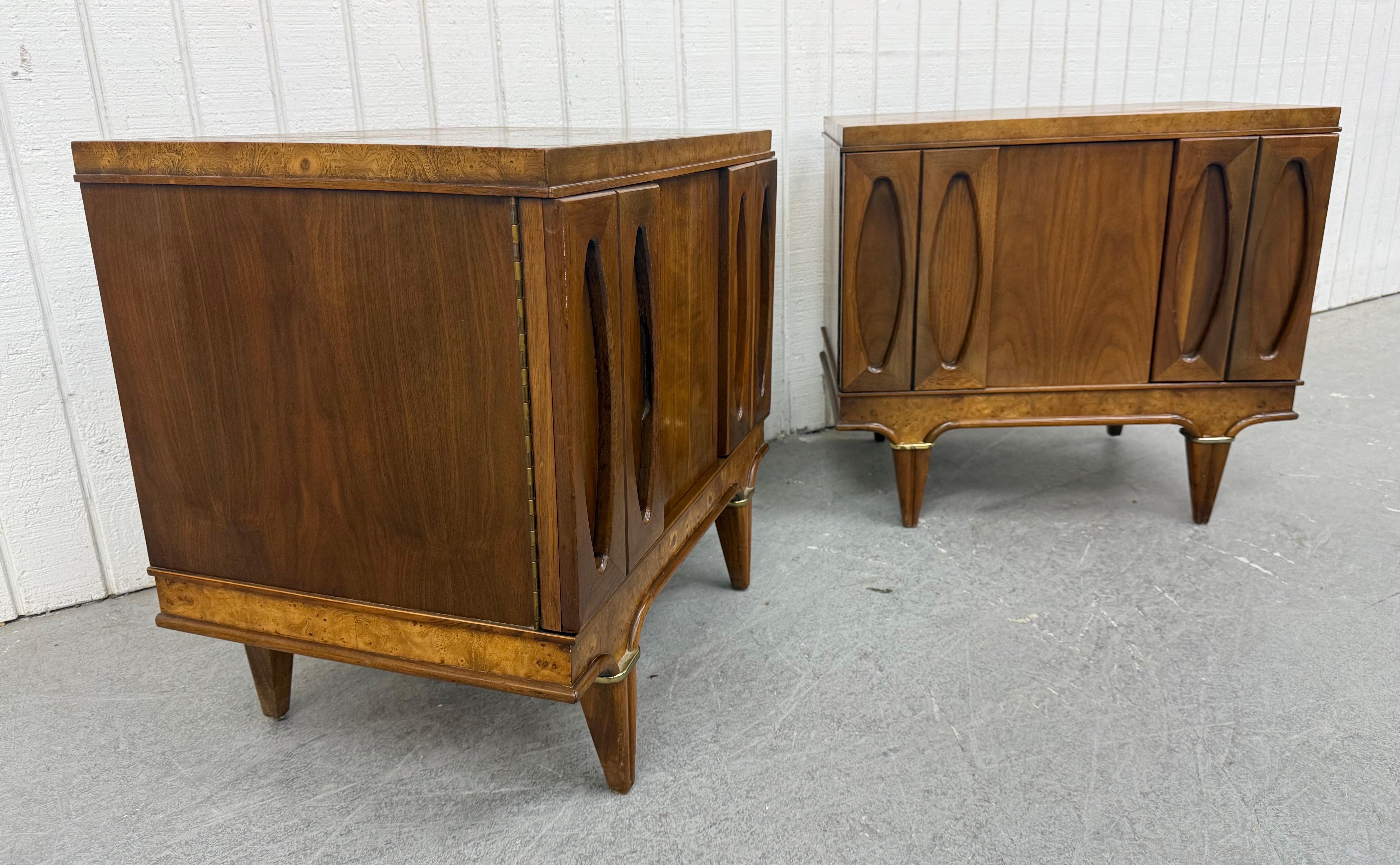 This listing is for a pair of Mid-Century Modern American of Martinsville Walnut Nightstands. Featuring a straight line design, two doors with oval design that open up to storage space, hidden drawer, modern legs, and burled wood accent. This is an