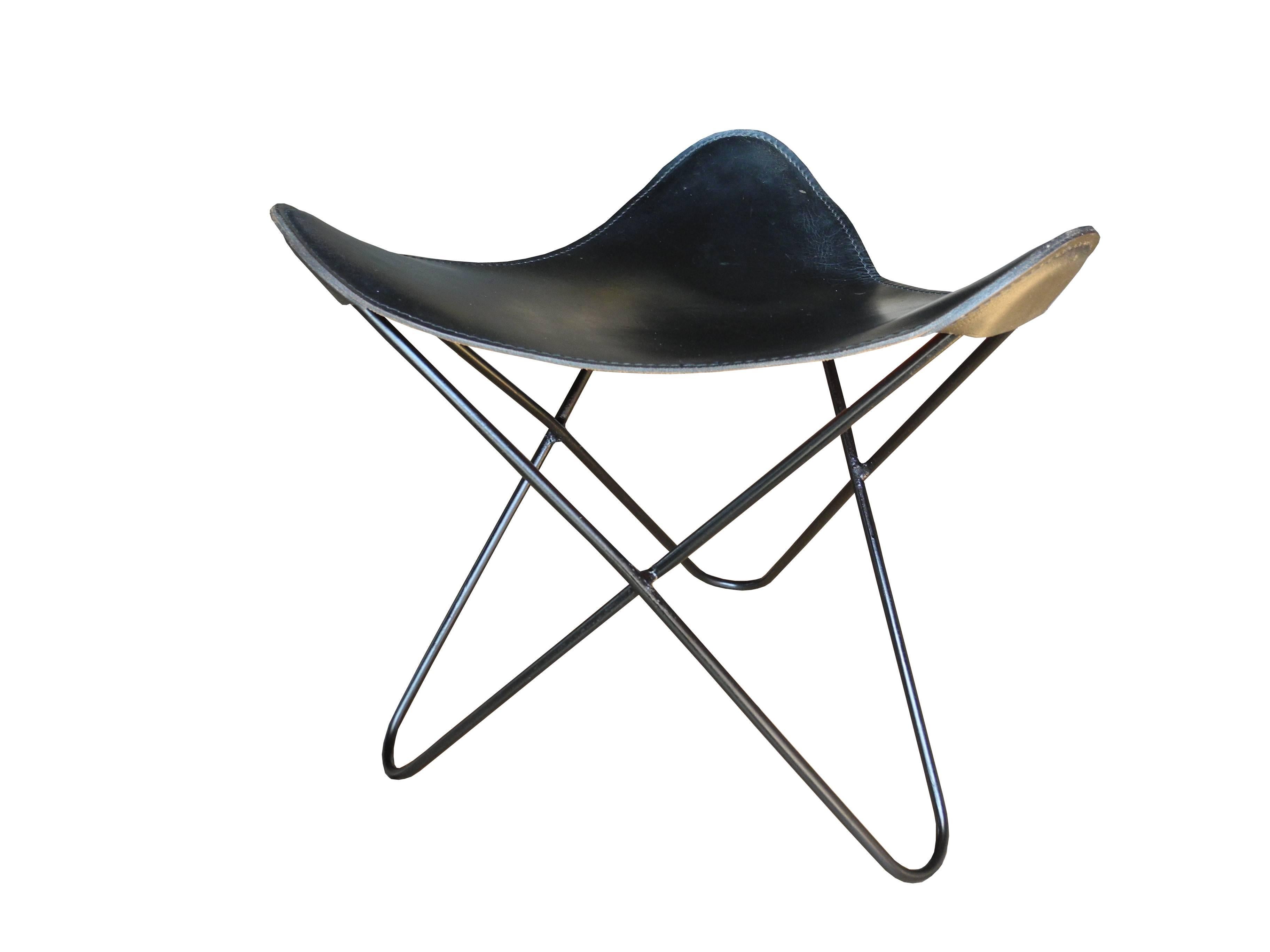 This simple welded steel stool has a saddle leather seat and is vintage American modern.
 