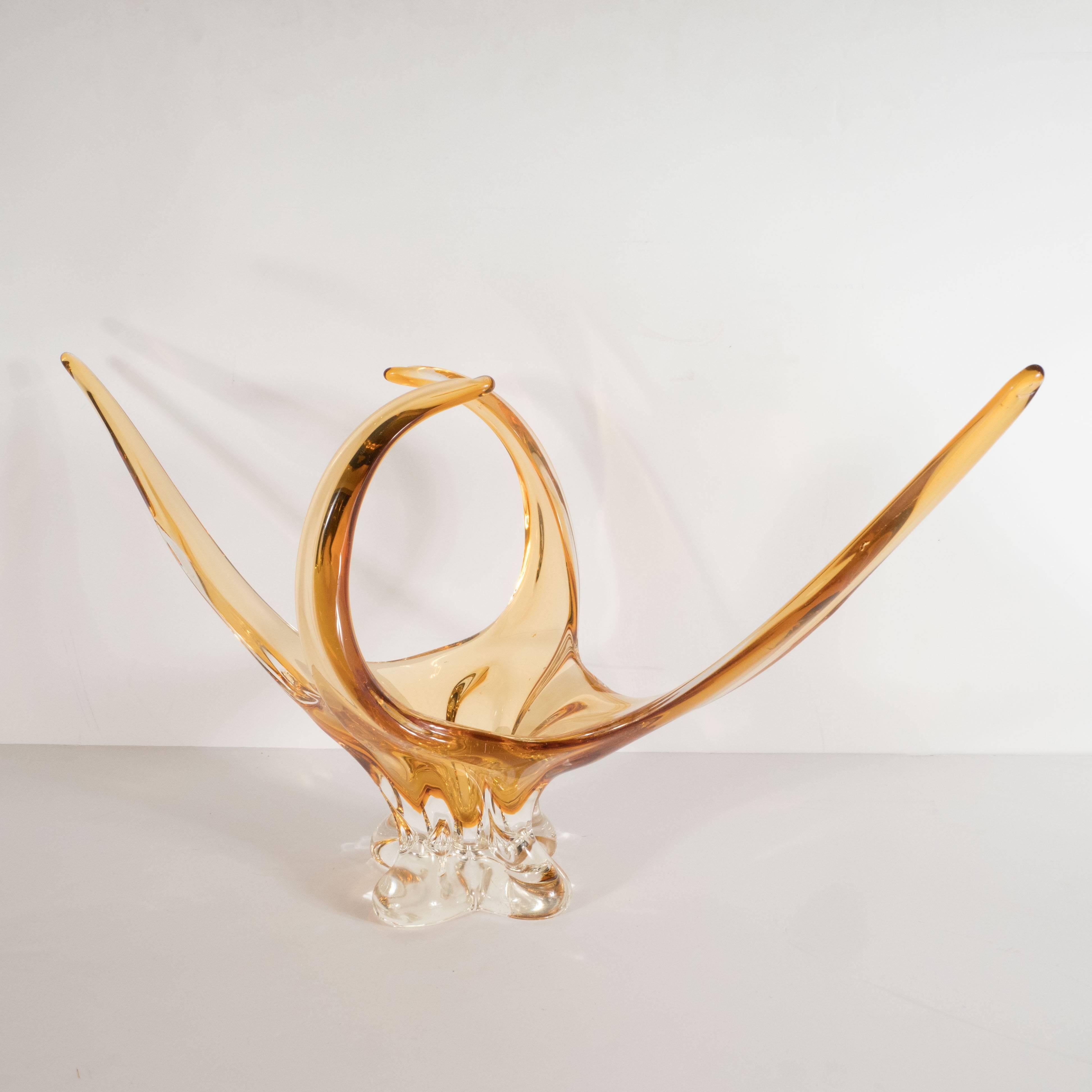 This stunning and graphic dish was handblown in Murano, Italy the islands off the coast of Venice renowned for centuries for their superlative glass production. This piece features four glass tendrils reaching skyward seemingly frozen in the midst