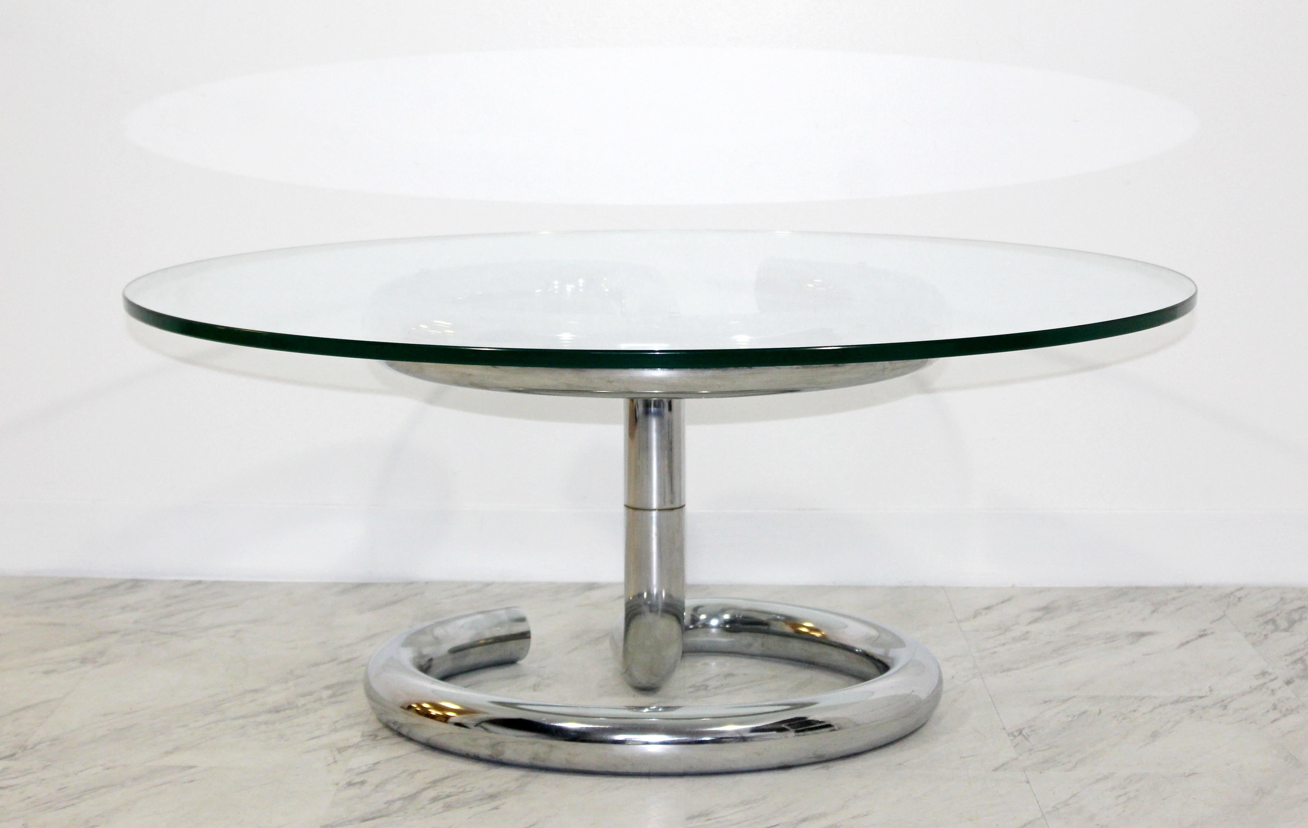 For your consideration is a magnificent coffee table, with an Anaconda chrome base and a circular glass top, by Paul Tuttle, circa the 1970s. In excellent condition. The dimensions are 40