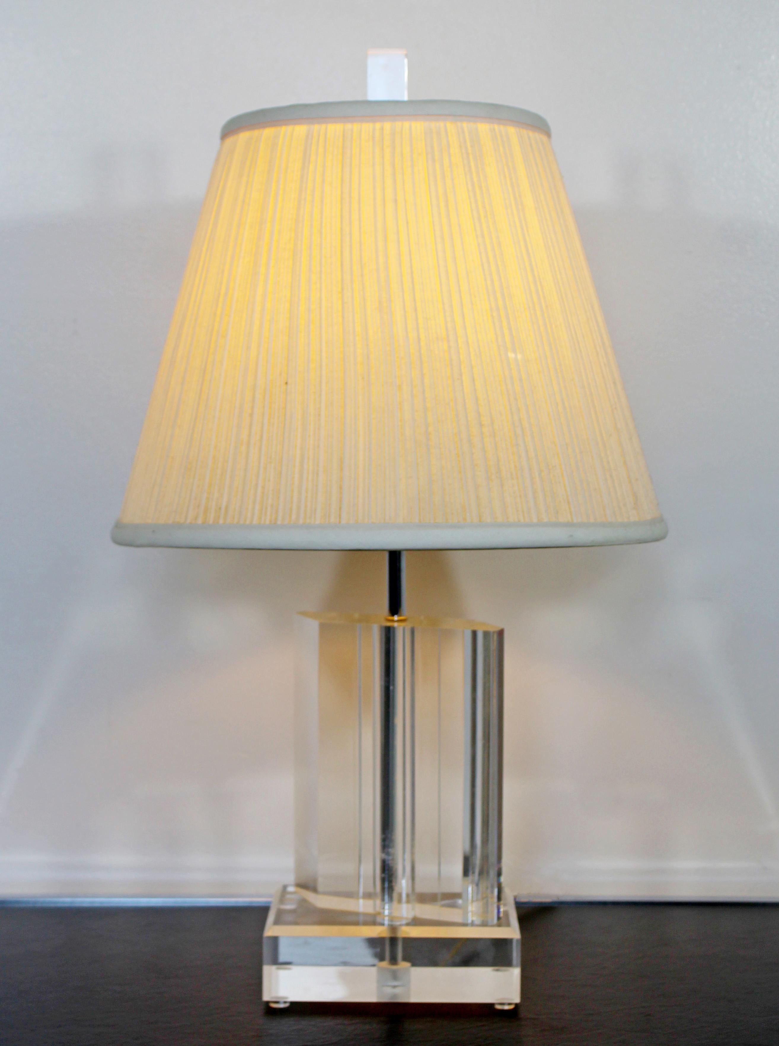 For your consideration is a wonderful, angled Lucite table lamp, with original shade and finial, in the style of Karl Springer, circa 1970s. In very good vintage condition. The dimensions of the lamp are 6.5