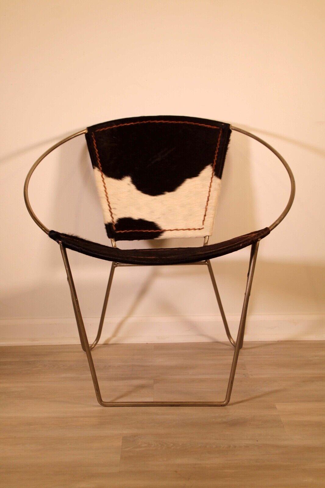 A sophisticated animal hide hoop chair. Iron material used for backbone of the chair. In very good condition. Dimensions: 30