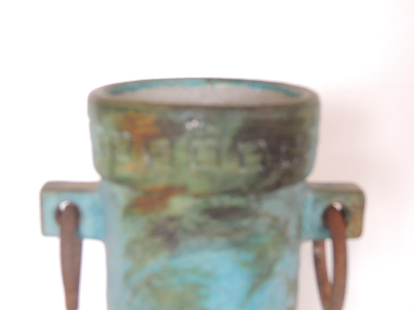 Mid-Century Modern aqua and green hand painted pottery vase with iron handles.
MOD style Italian round vase with indented details all around base and top.
with two round rustic iron handles.
Signed: ITALY
Size: 5