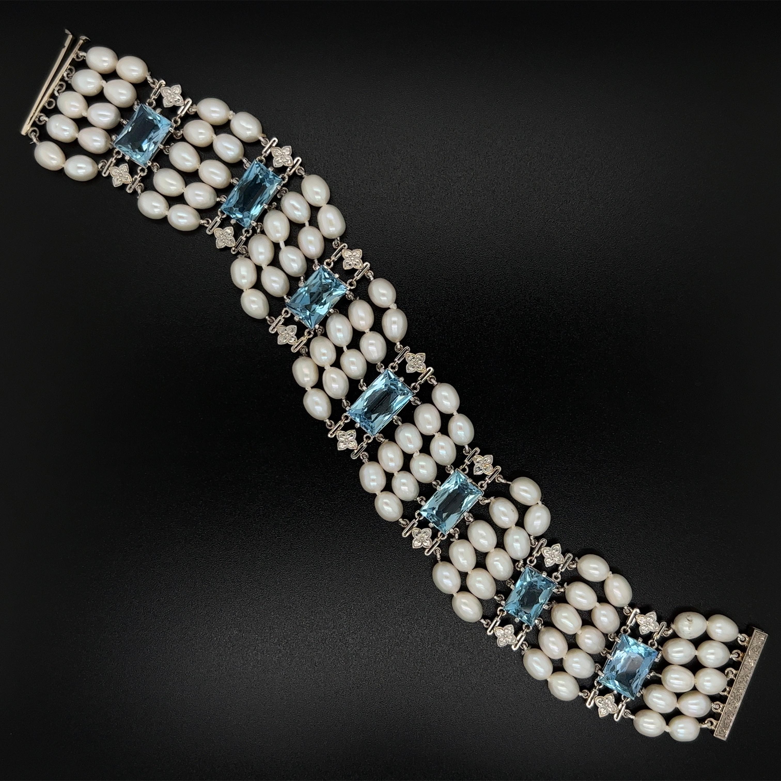 Simply Beautiful! Mid Century Modern Aquamarine and Pearl 5 Strand Bracelet. Featuring 7 rectangular Deep Blue Aquamarines weighing approx. 28tcw. inter-spaced with Pearls. Bracelet measures approx. 7.5” l x 1” w. Circa 1950s. More Beautiful in real