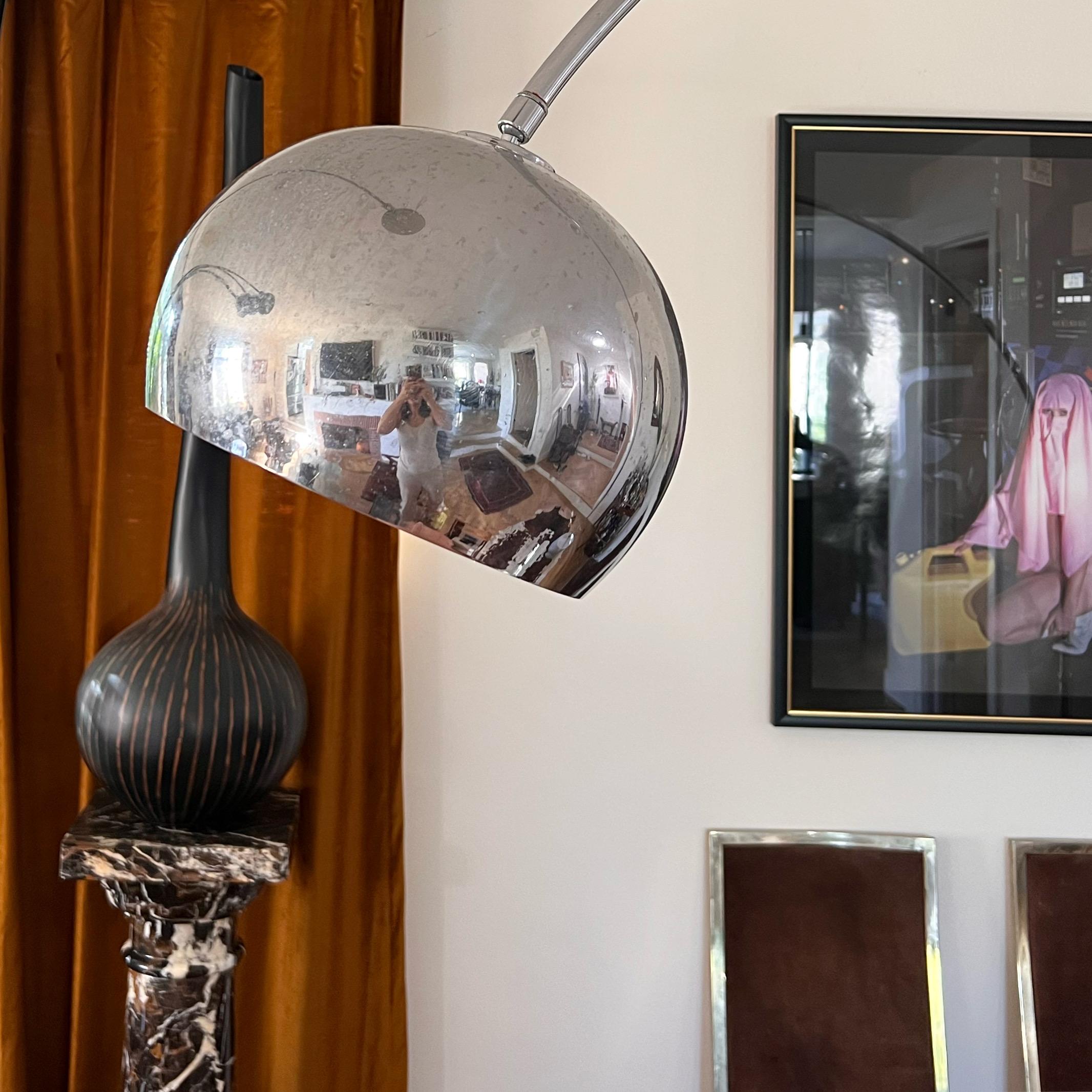 A true Mid-Century Modern arced metal floor lamp after Achille Castiglioni, made in Italy circa 1960s. The chrome arc and bulb shade do detach from the marble base for easier storage and transport; marble base is solid and exceedingly heavy. A