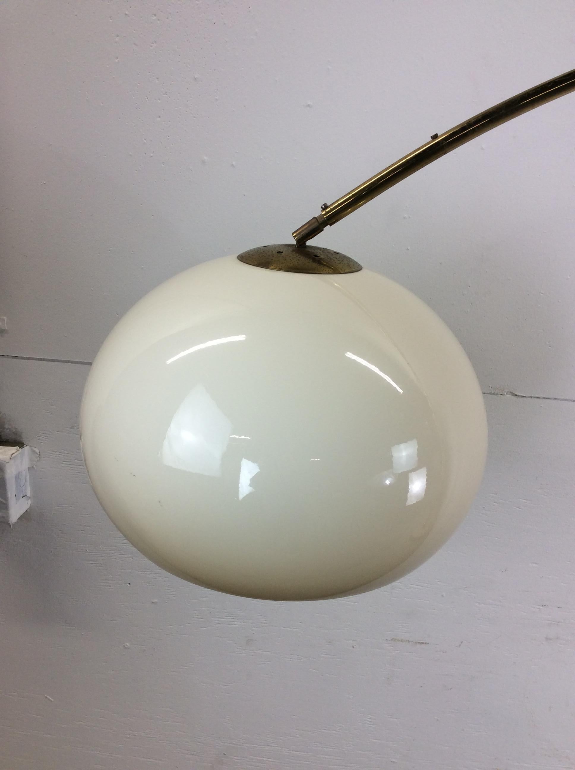 This mid century modern floor lamp features extending brass arm, brass accented travertine base, vintage wiring with foot switch, and unique molded plastic globe.  Expandable between 48” wide to 85” wide

Dimensions: 85w 17d 70.5h

Condition notes: