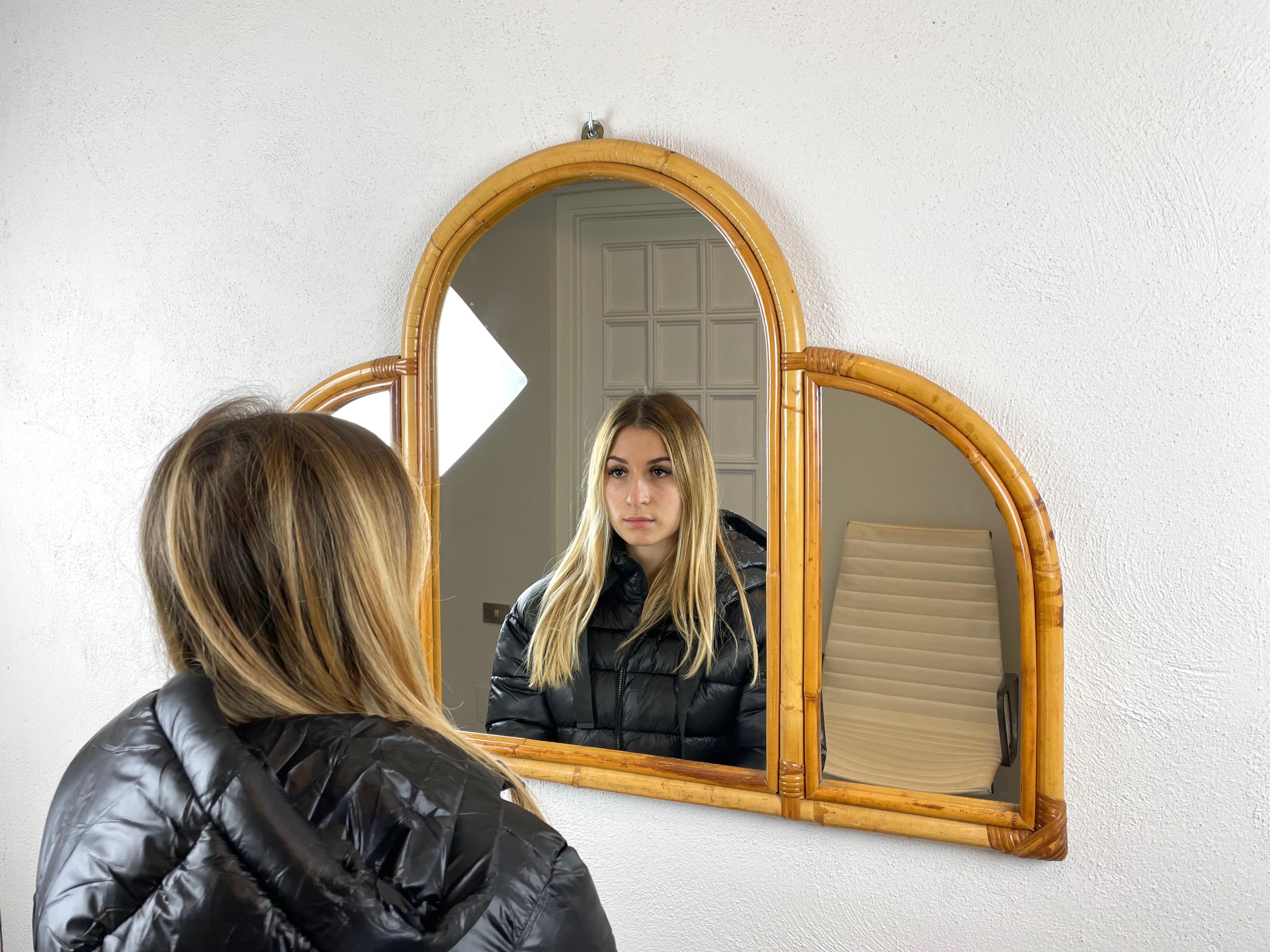 Mid-Century Modern wall mirror composed of three arches with bamboo frame made in Italy.