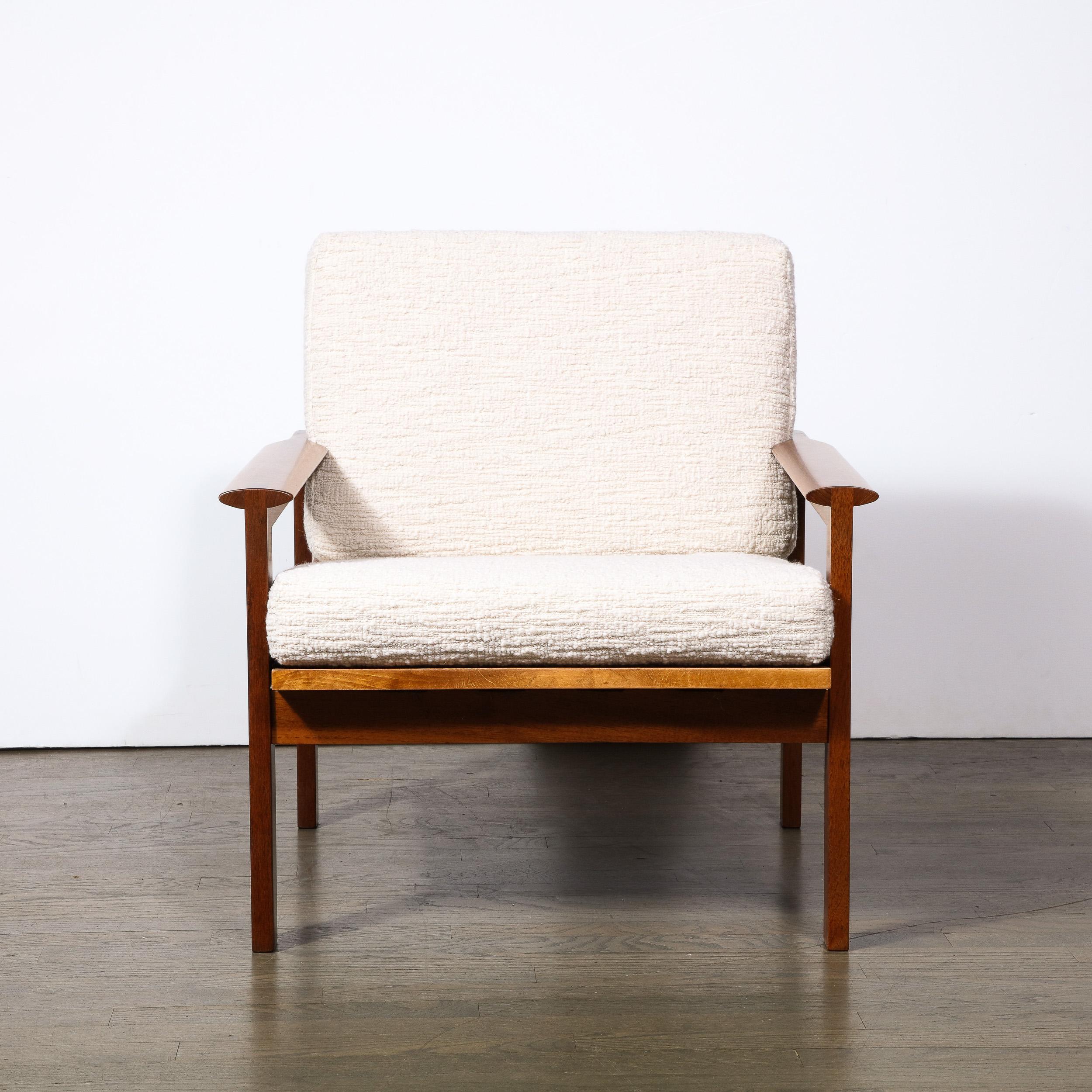 This refined Scandinavian Mid-Century Modern armchair was realized by the esteemed designer George Tanier in Denmark circa 1960. This piece is a study simplicity of first rate design, and how elemental forms can be combined to a powerful effect (as