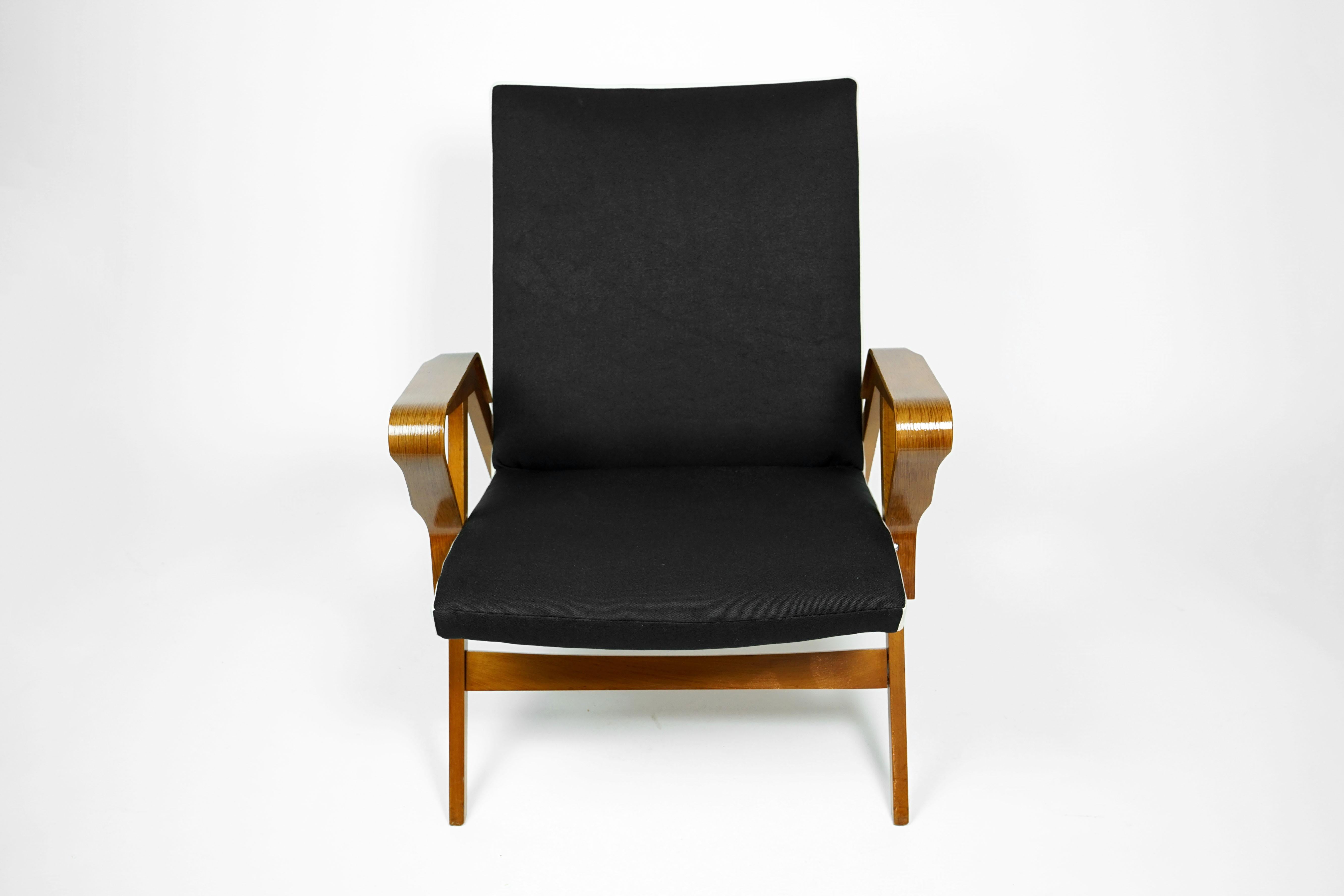 Extraordinary armchair, by manufacturer Tatra, former Czechoslovakia.

The chair is completely restored and in an excellent condition.
The armrests are bended oak and beechwood have been re-polished in a shiny walnut tone. Reupholstery is in a