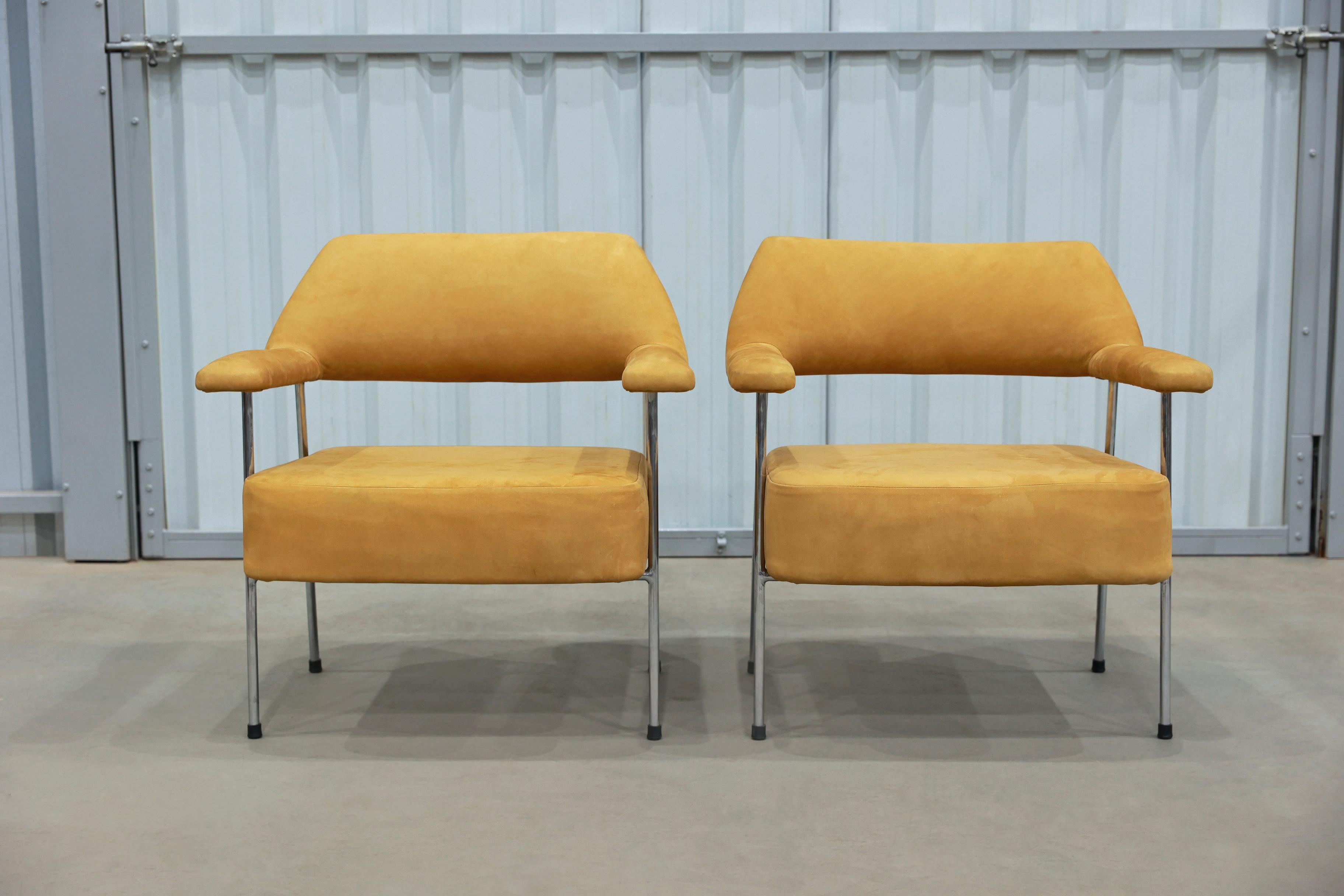 These armchairs by Joaquim Tenreiro are nothing less than specatcular.

The structure of these two chairs is made with painted tubular metal. It features a mustard suede upholstery. The iron has been repainted and refinished and the seats have been